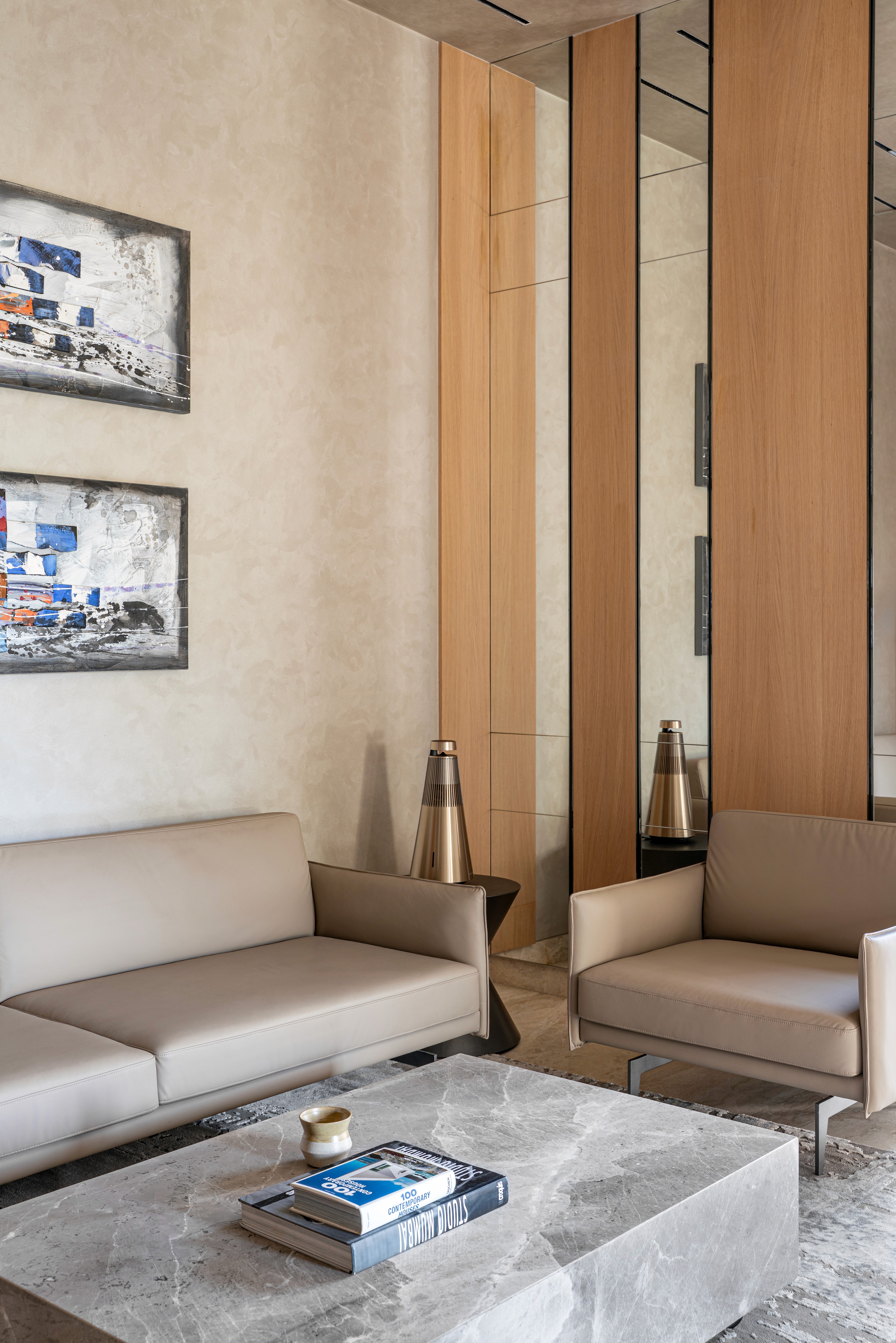 A stunning architectural interior featuring a modern staircase with flowing wooden curves and sleek lines, highlighted by soft lighting for a sophisticated ambiance.