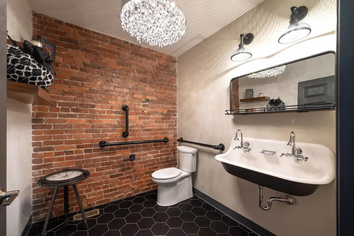 Bathroom with green cabinets and marble shower