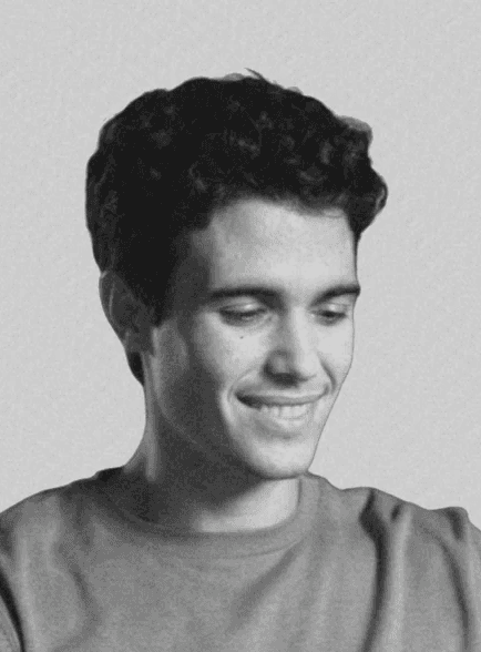 Portrait of a woman with long, smooth hair swept to the side, in a dark t-shirt, on a plain background.