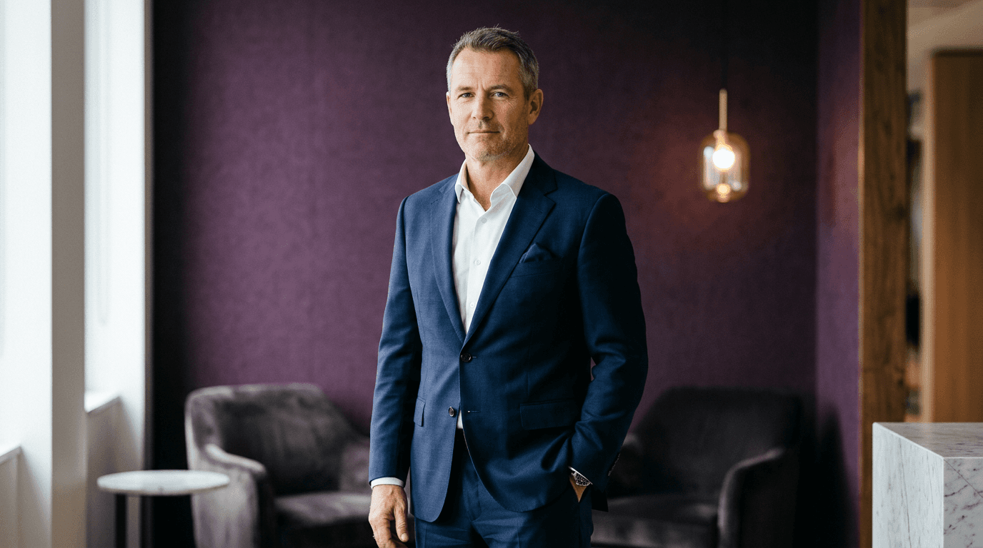 Confident senior communications leader standing in a modern office, composed and forward-looking