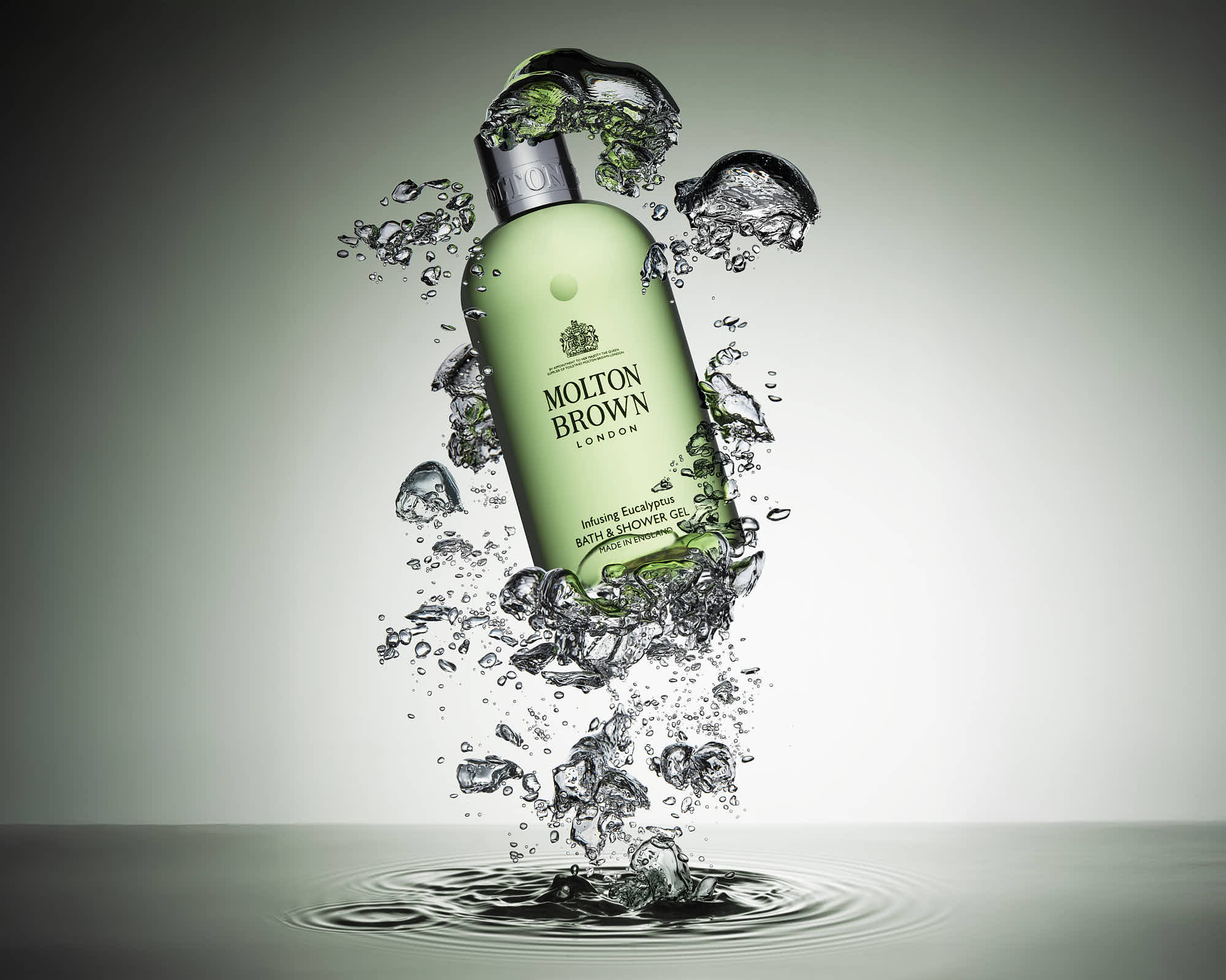 A green cosmetic appears to explode, surrounded by dynamic bursts of bubbles against a light background.