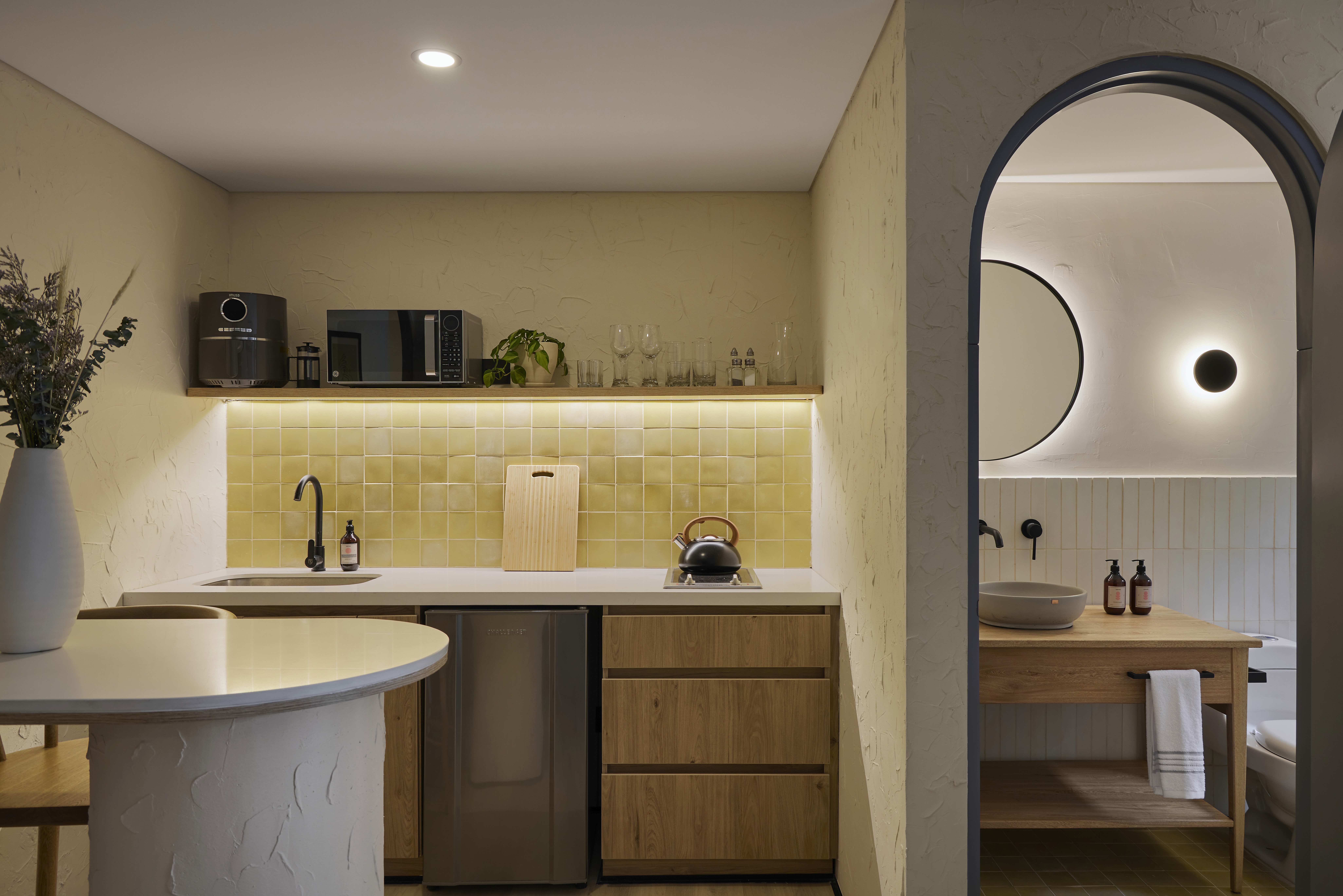 Double-height interior with flowing sculptural forms and warm raking light