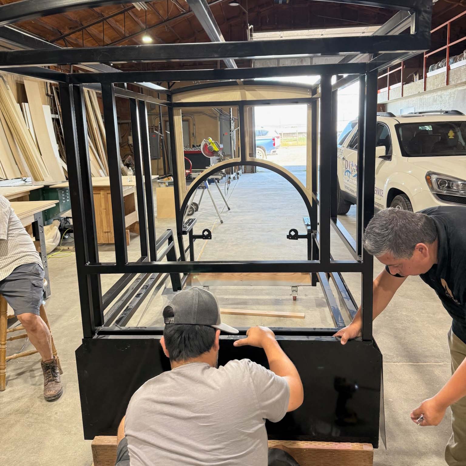 Workers working on train in shop