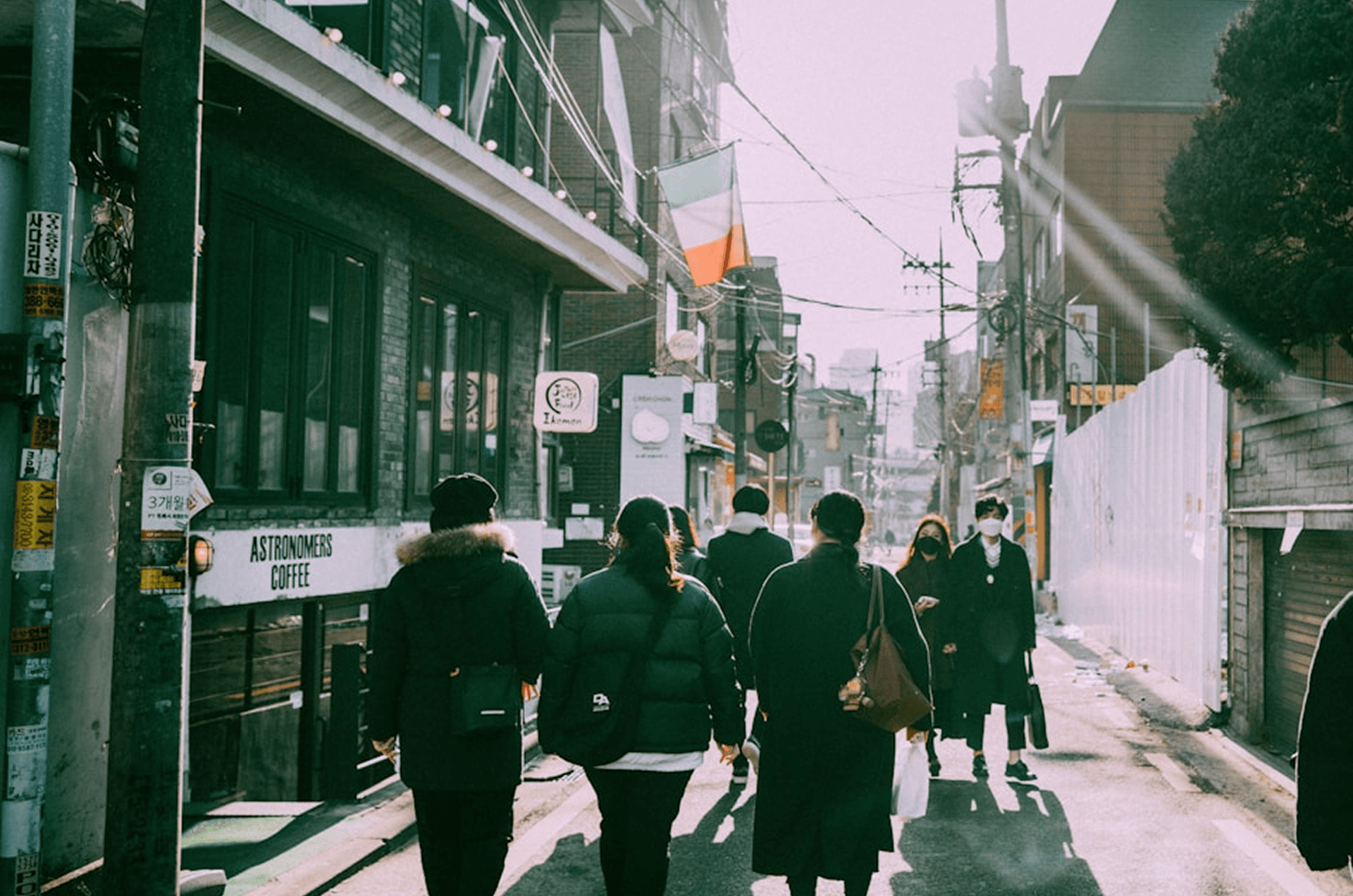 Crowd walking past Astronomie coffee shop in urban alley, symbolizing the best B2B lead generation platforms directing qualified prospects to your pipeline in 2026