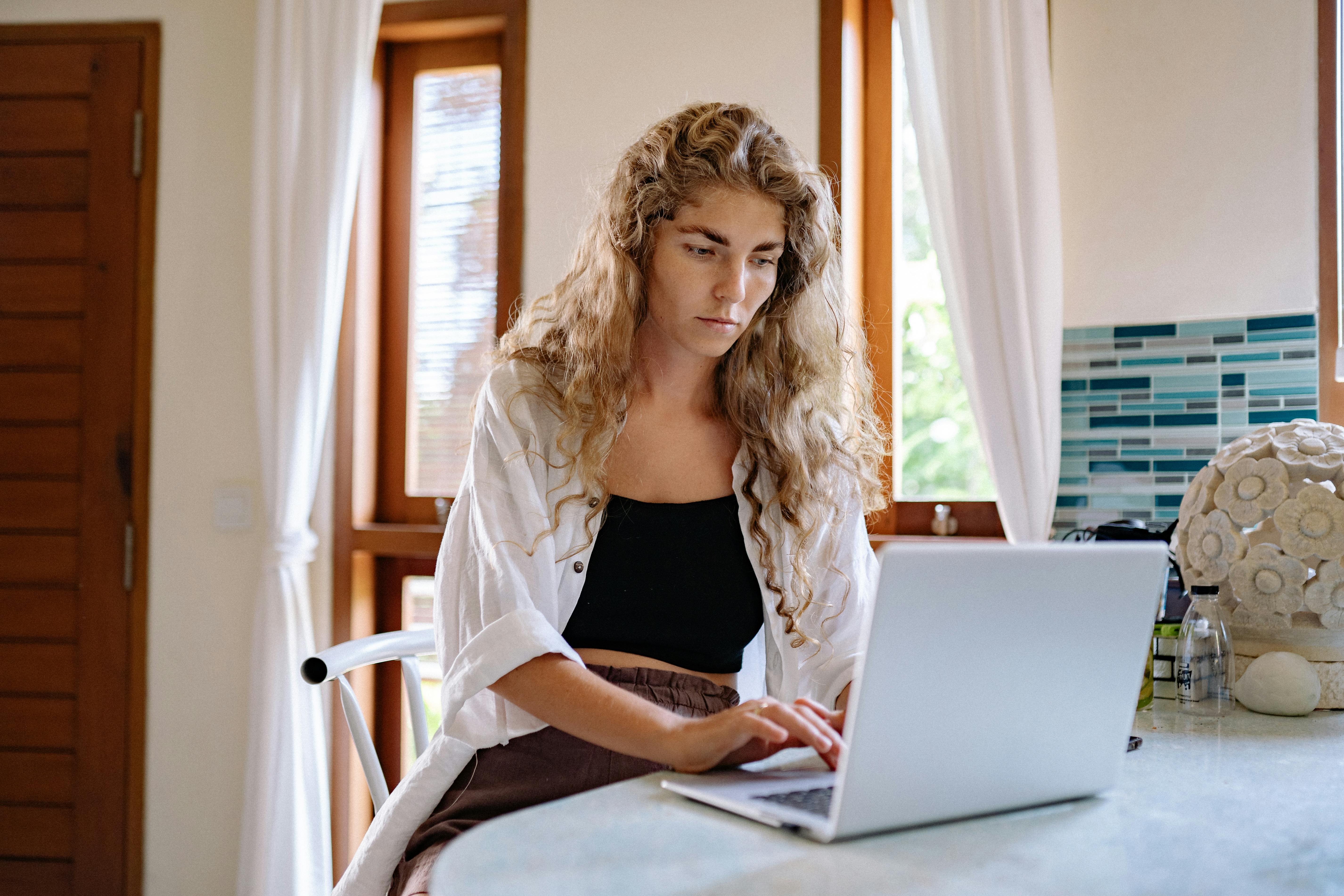 Woman using her laptop boosting open rate