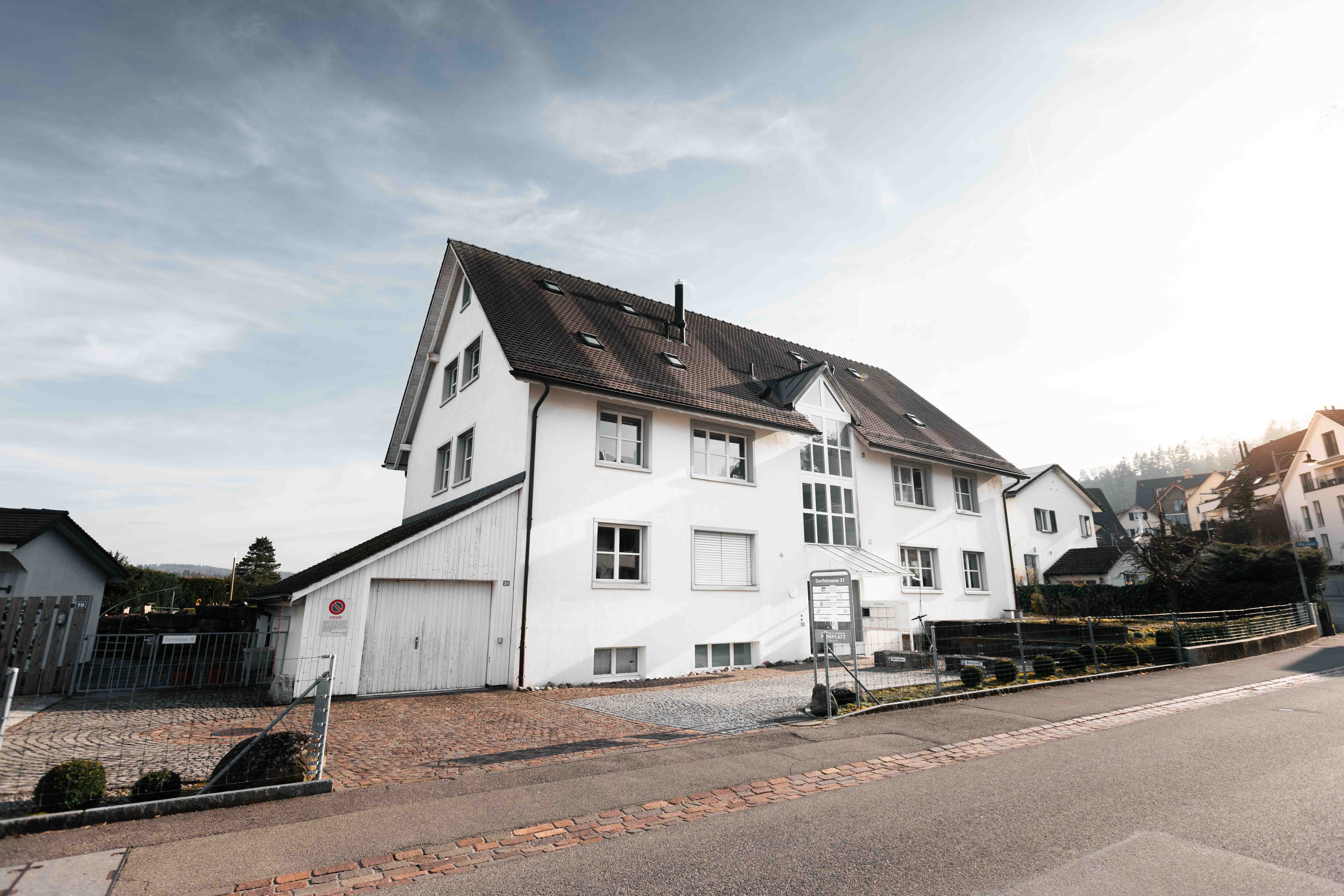 An empty road with a hospital in the background.