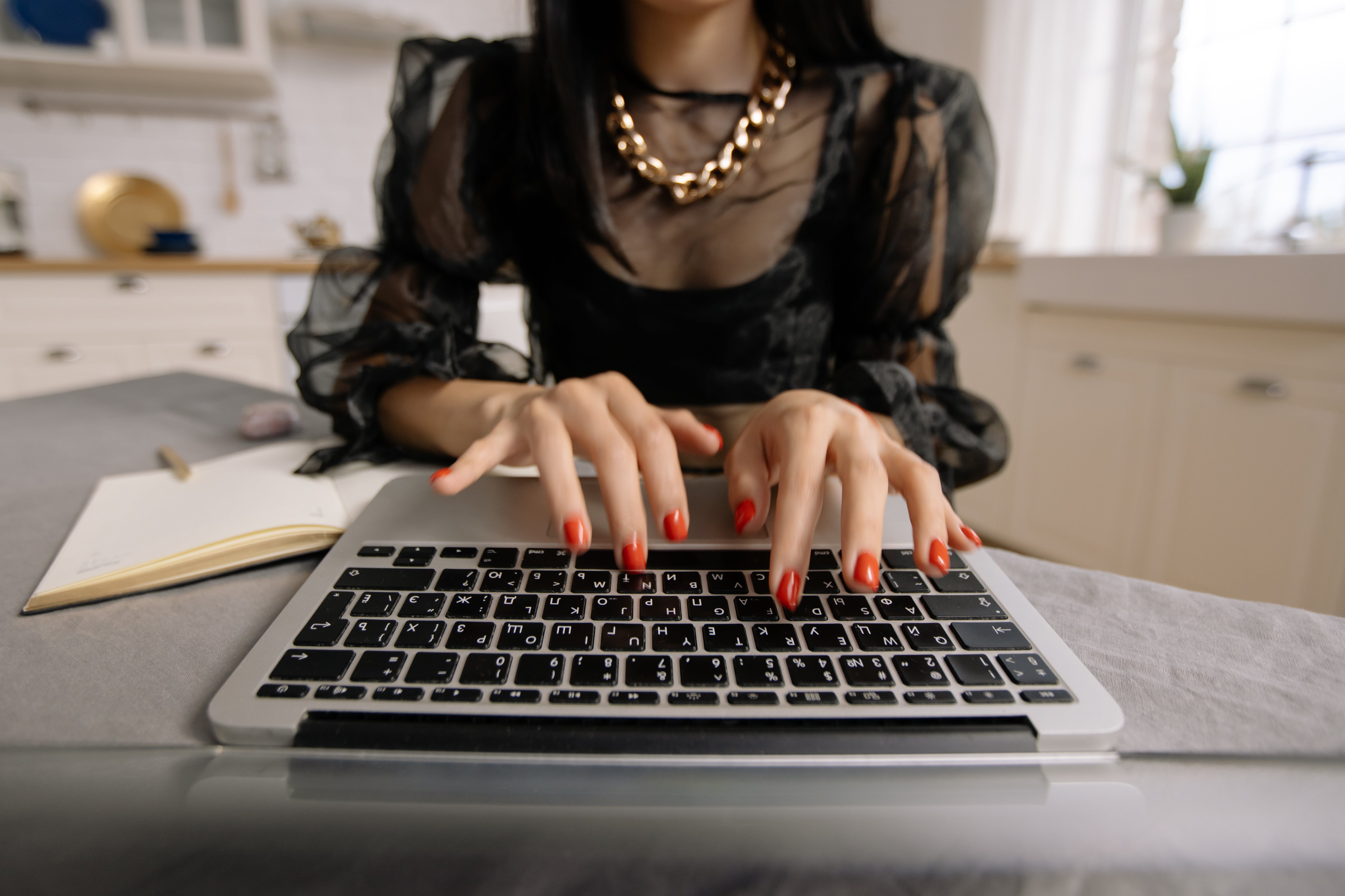 Woman using laptop reaching out to brands through cold emails