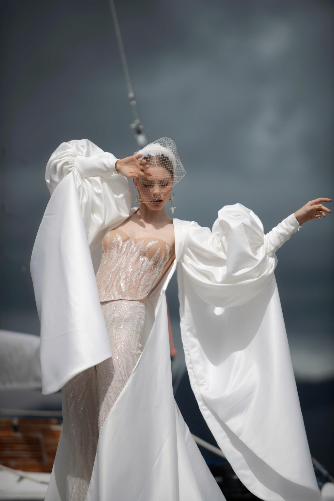 Bold editorial fashion portrait of model in houndstooth blazer with red tie and green shirt against bright turquoise background - Serif Creative Studio luxury fashion photography