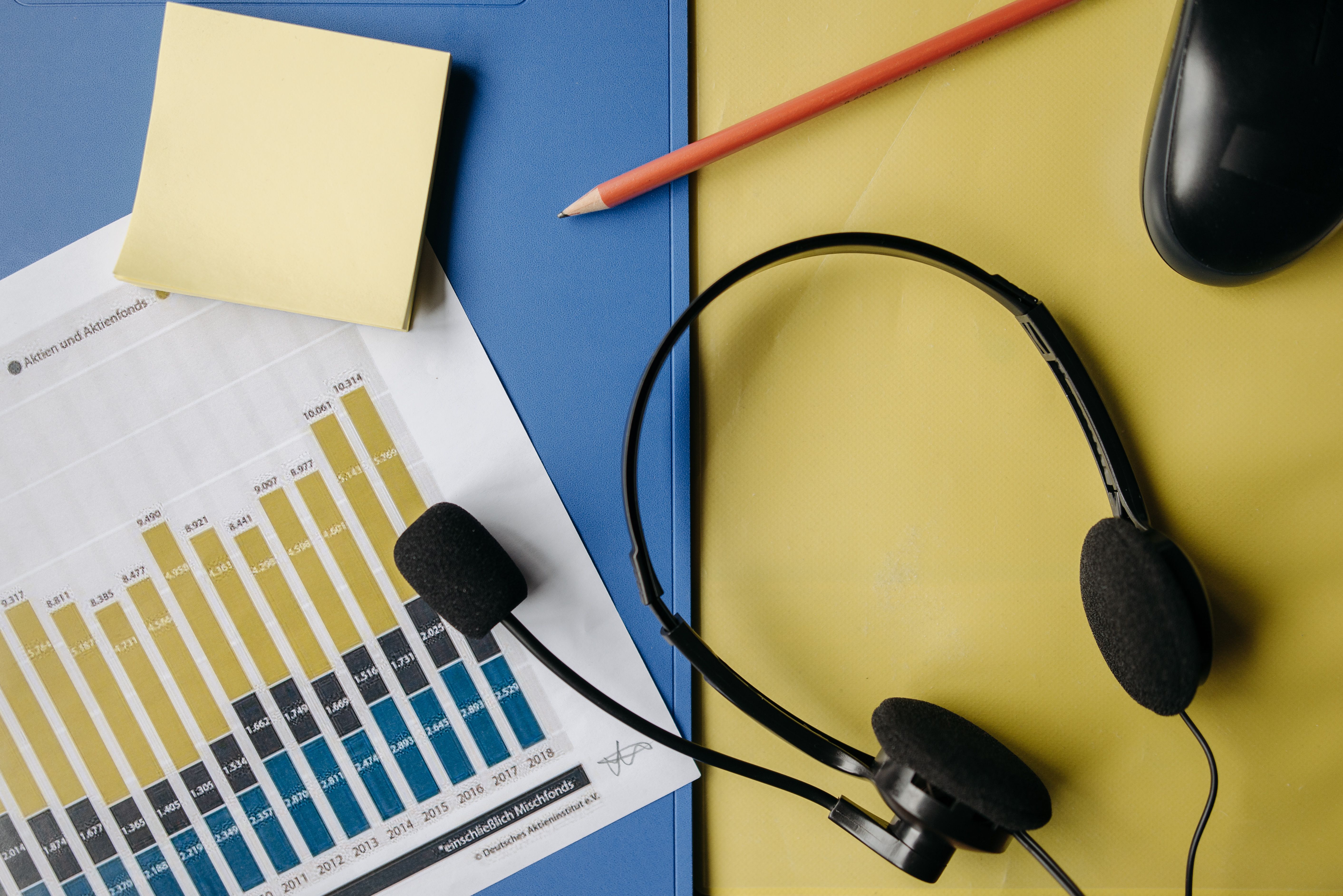 a-flat-lay-image-depicting-an-office-desk-with-a-headset,-chart,-and-stationery- - pavel-danilyuk (pexels)
