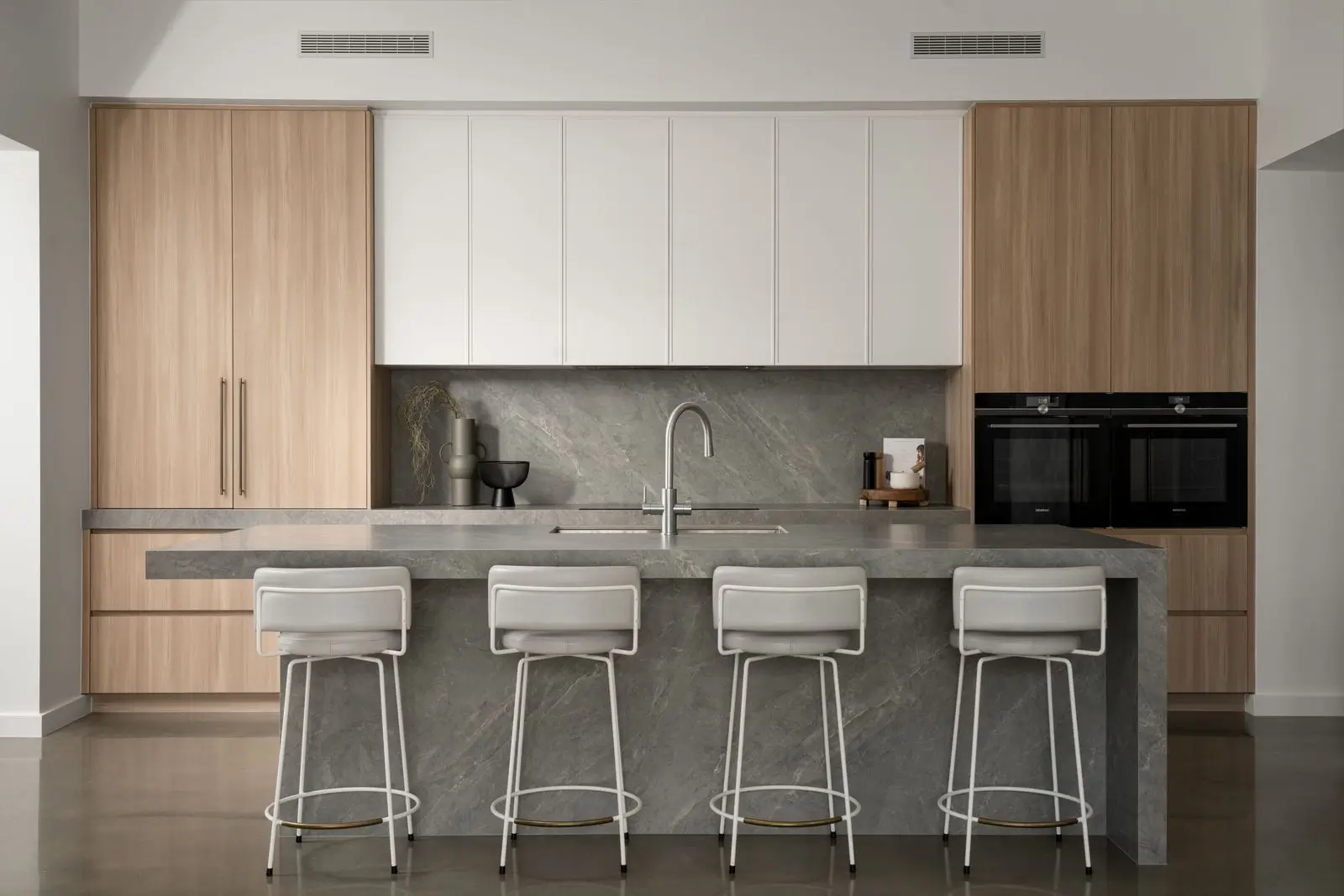 Spacious kitchen with plenty of storage and island bench with one waterfall end