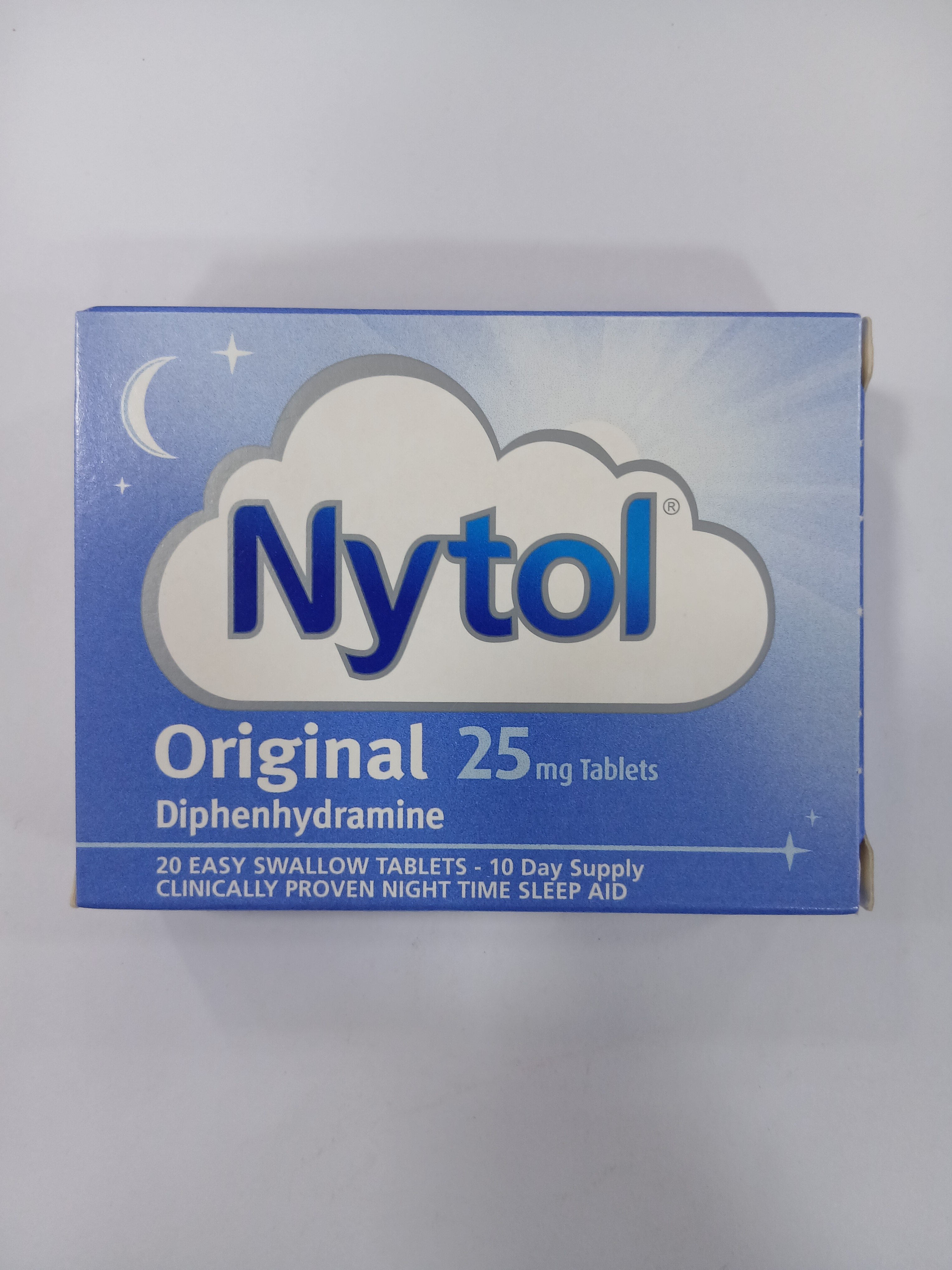 A blue cardboard box packaging displays white text and graphics, including a cloud with a crescent moon, listing "25 mg tablets" and "20 easy swallow tablets - 10 day supply" for a clinically proven night-time sleep aid.