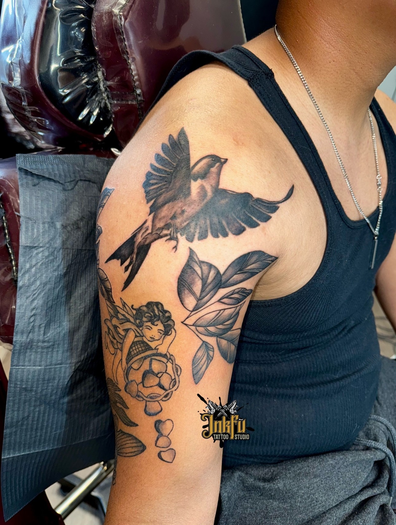 Black and grey sparrow and botanical sleeve piece on the shoulder, by Meer Rich