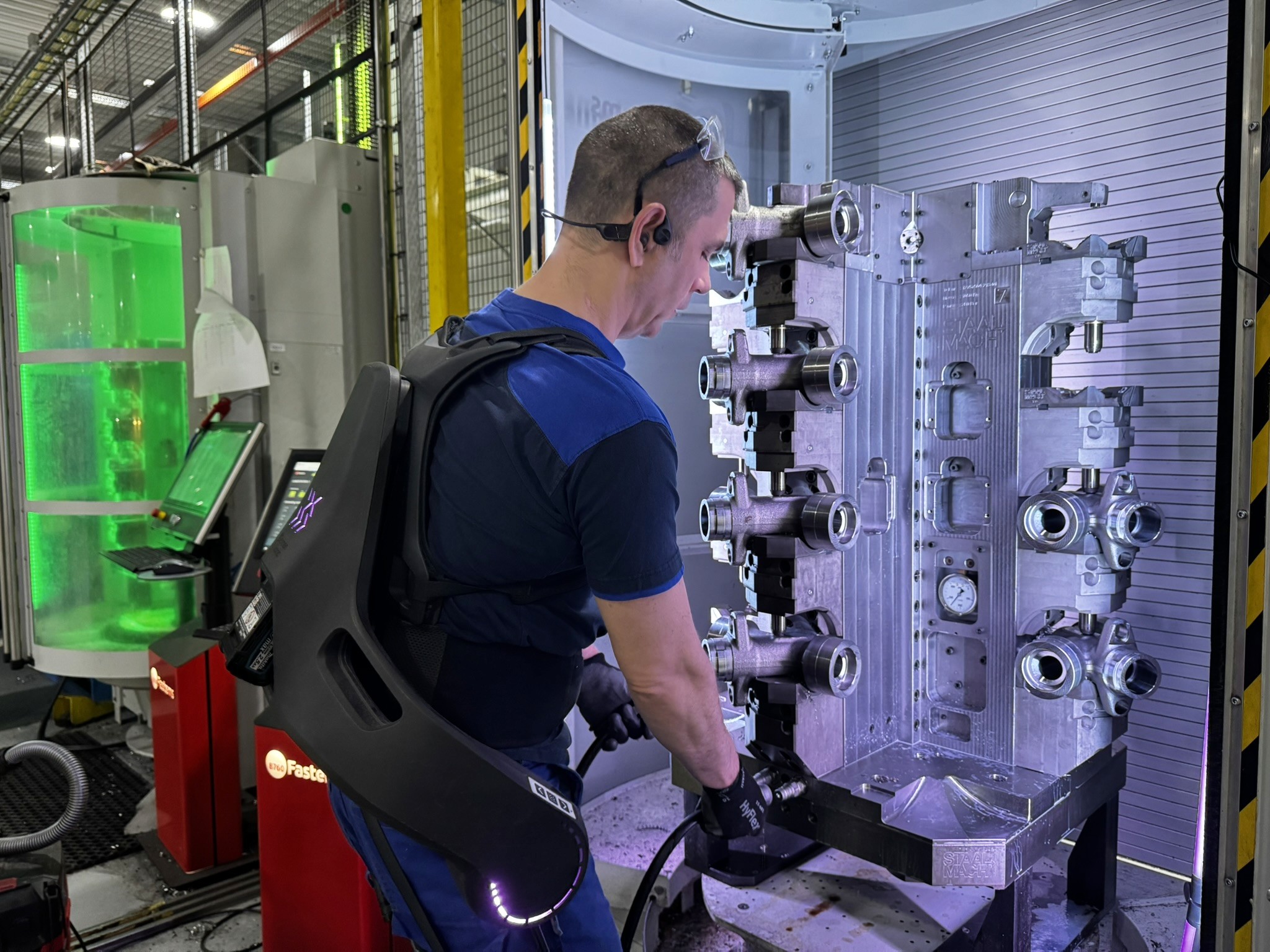 Exoskeleton worn by man in machining environment