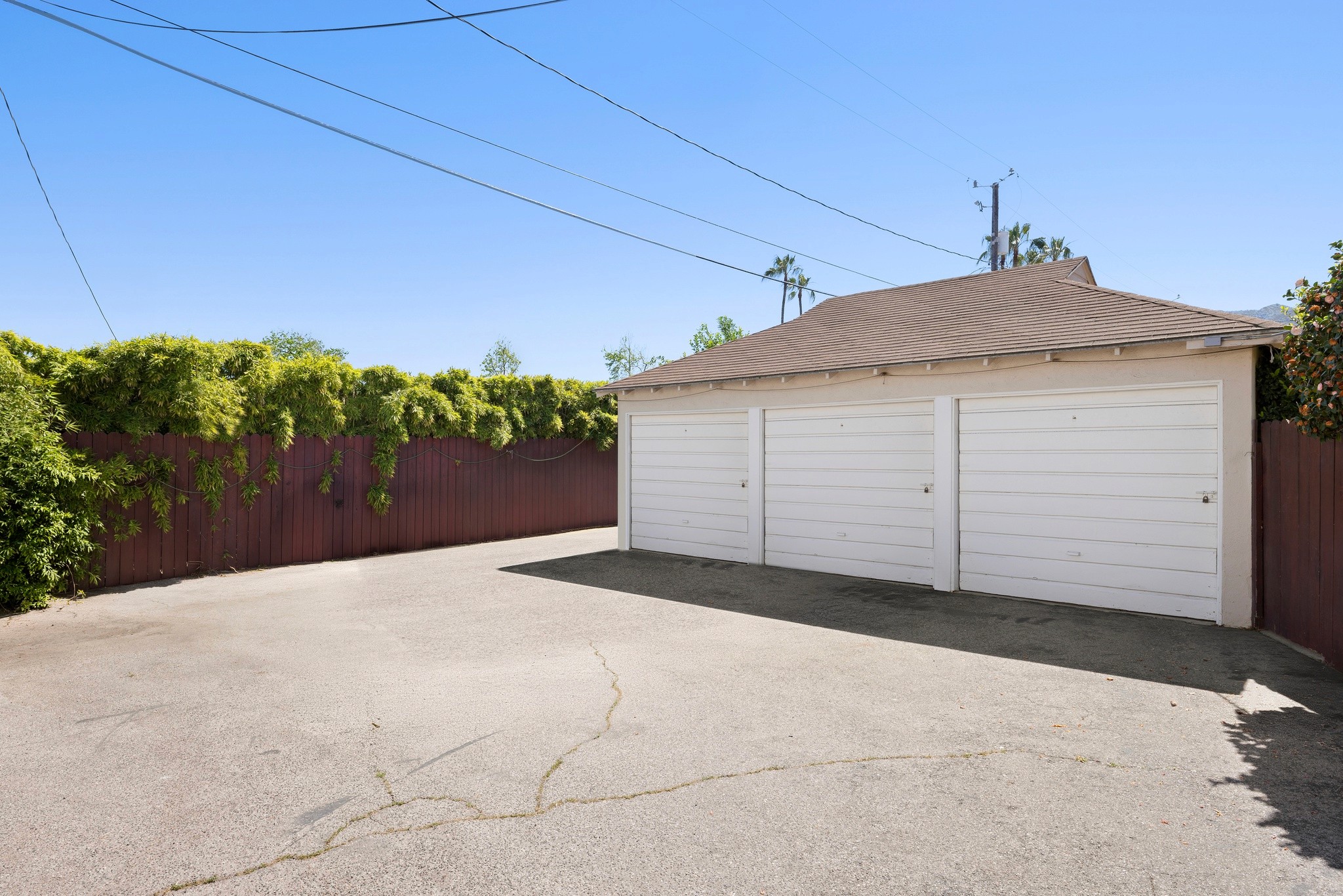 Back view of garages and duplex structure with parking area at 242 N Cordova in Burbank.