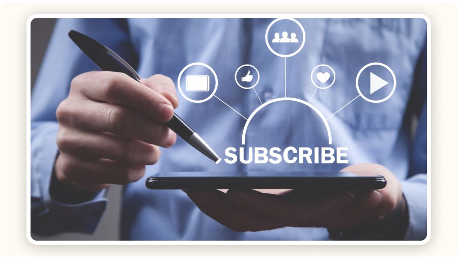 Person using tablet with stylus and “Subscribe” digital marketing icons