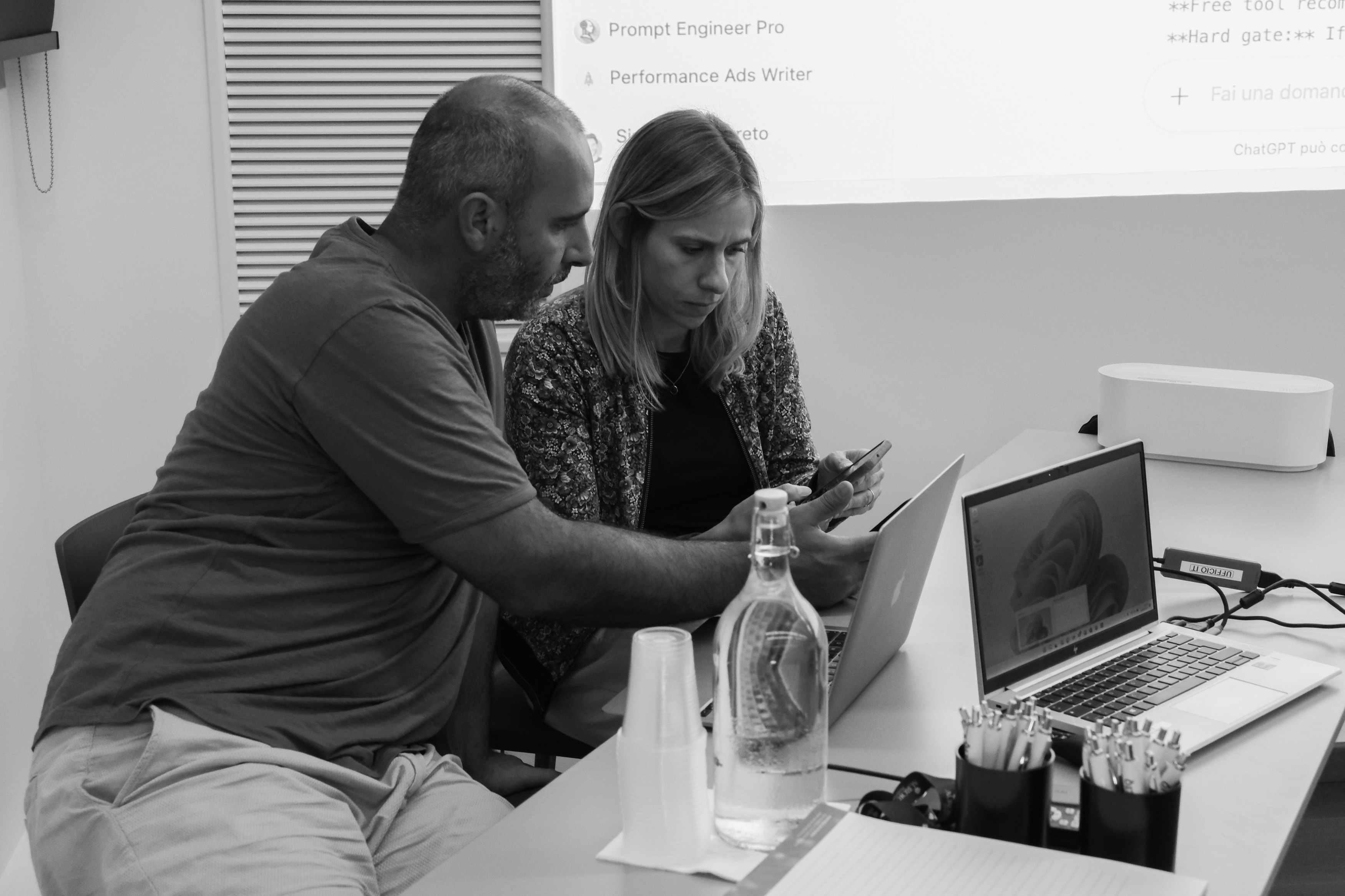 due persone che scrivono note sulla scrivania