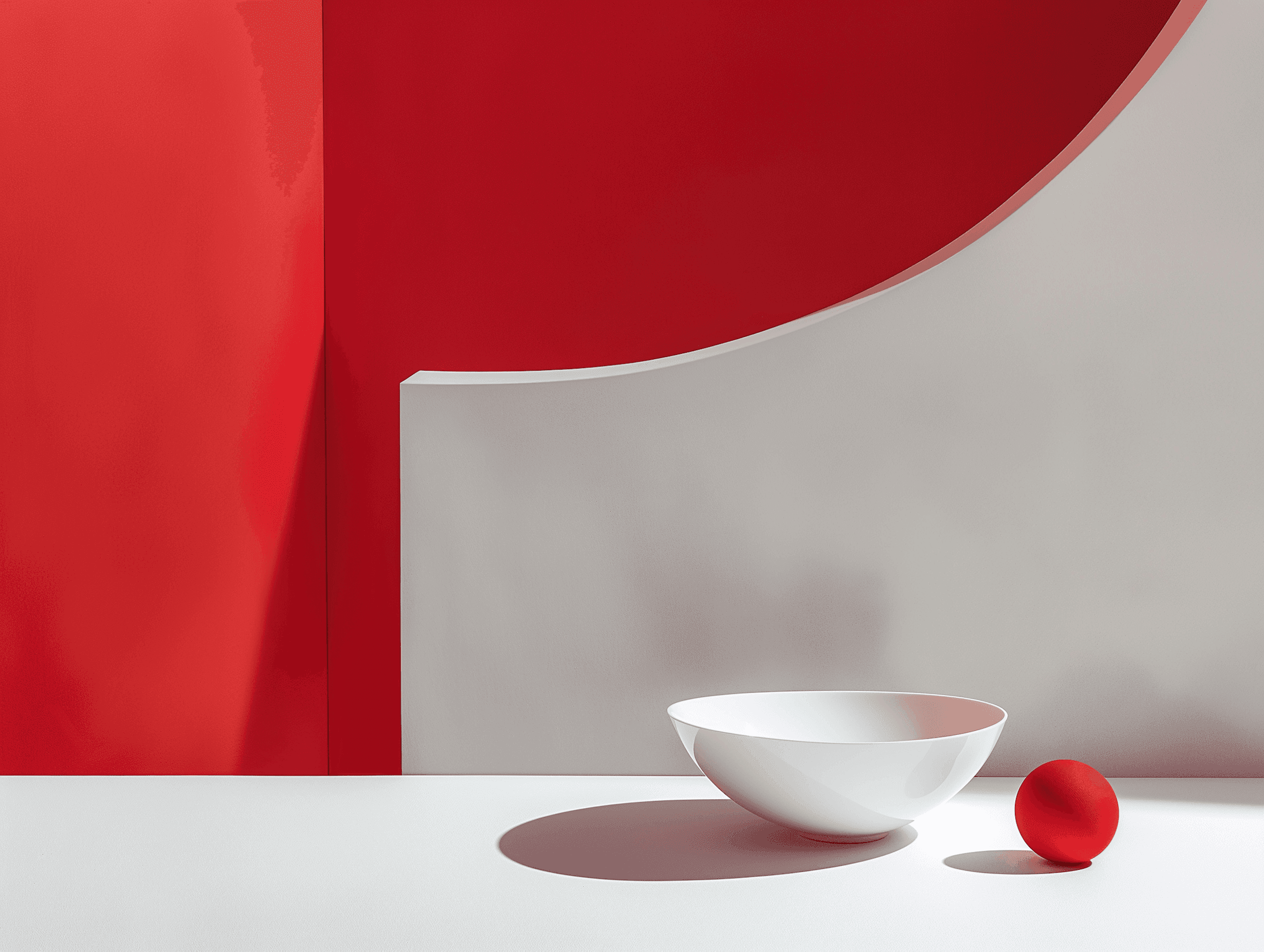 Modern still life with white bowl and red sphere on sculptural surface