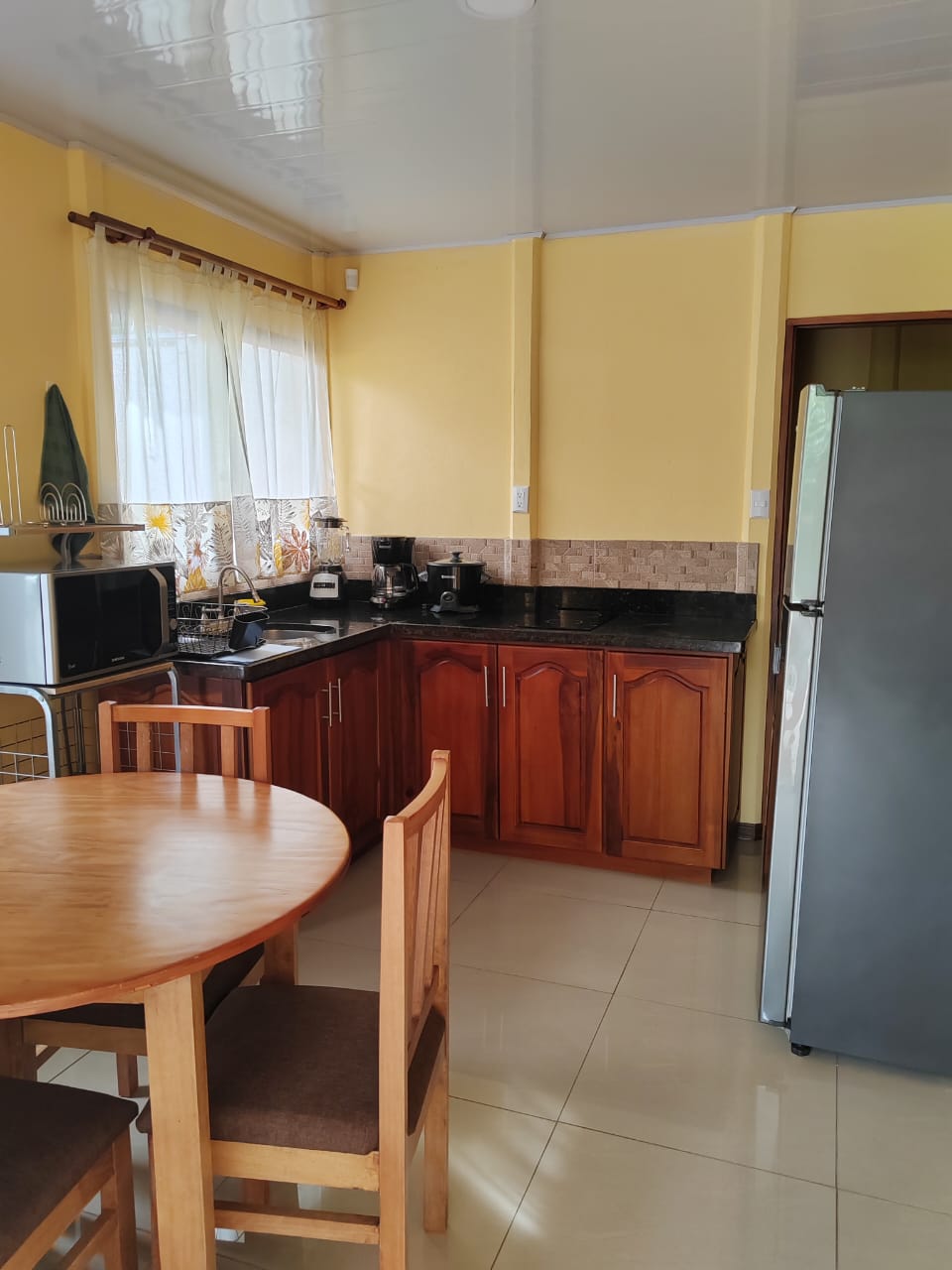 an aerial view of a beach surrounded by trees