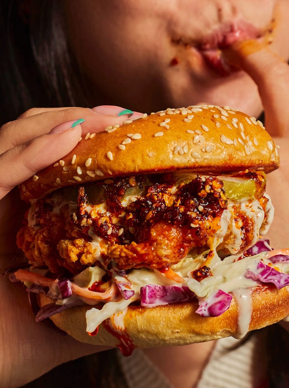 A beautifully plated dish featuring shrimp, colorful vegetables, and garnishes, set in a modern restaurant.
