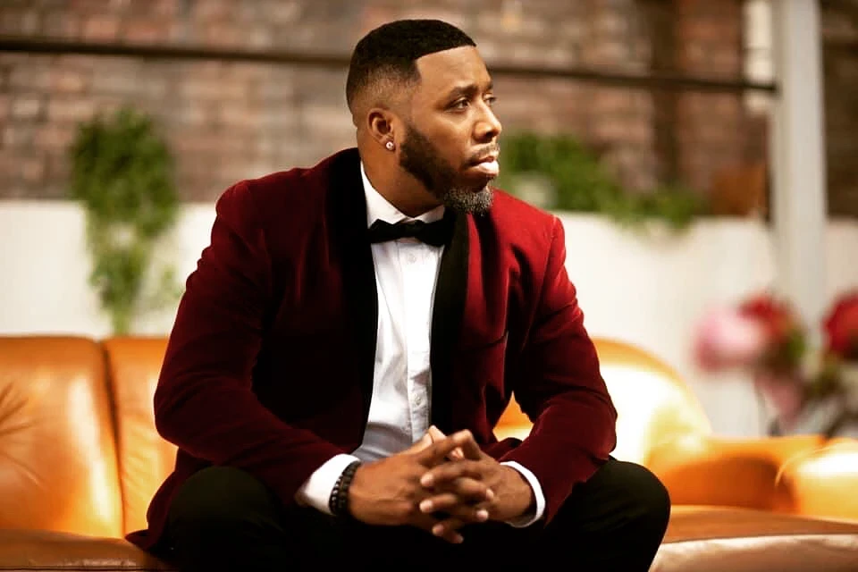 Man with gold accents and dramatic lighting, modern portrait aesthetic