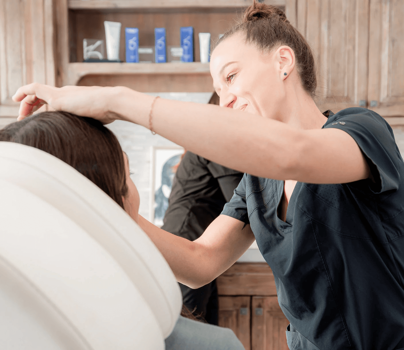 Chelsey Galipeau injecting a male patient's scalp for hair restoration service