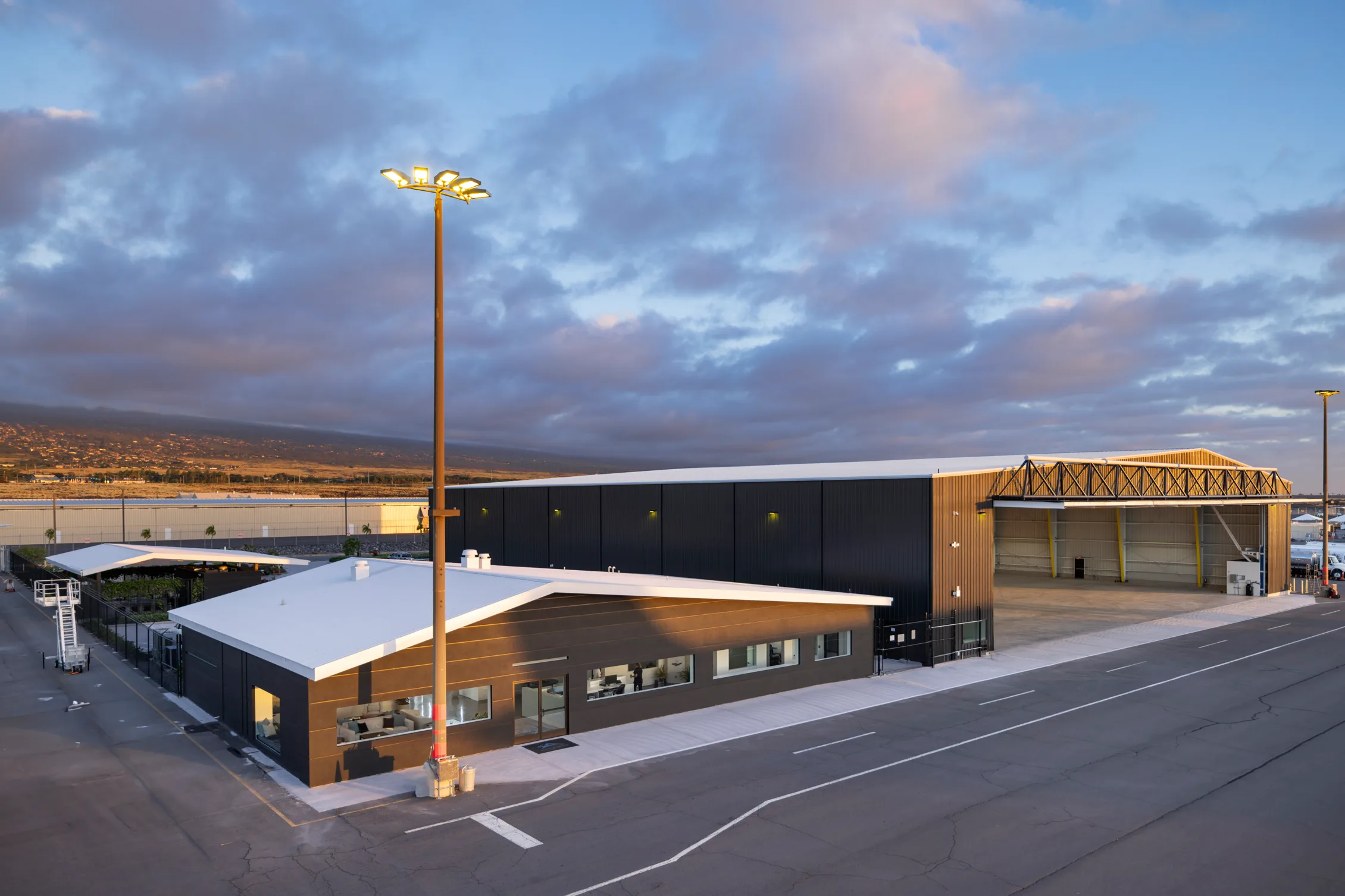 Private aviation hangar and offices at dusk, Kona