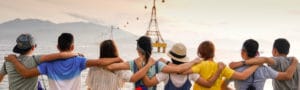 people holding shoulders sitting on wall
