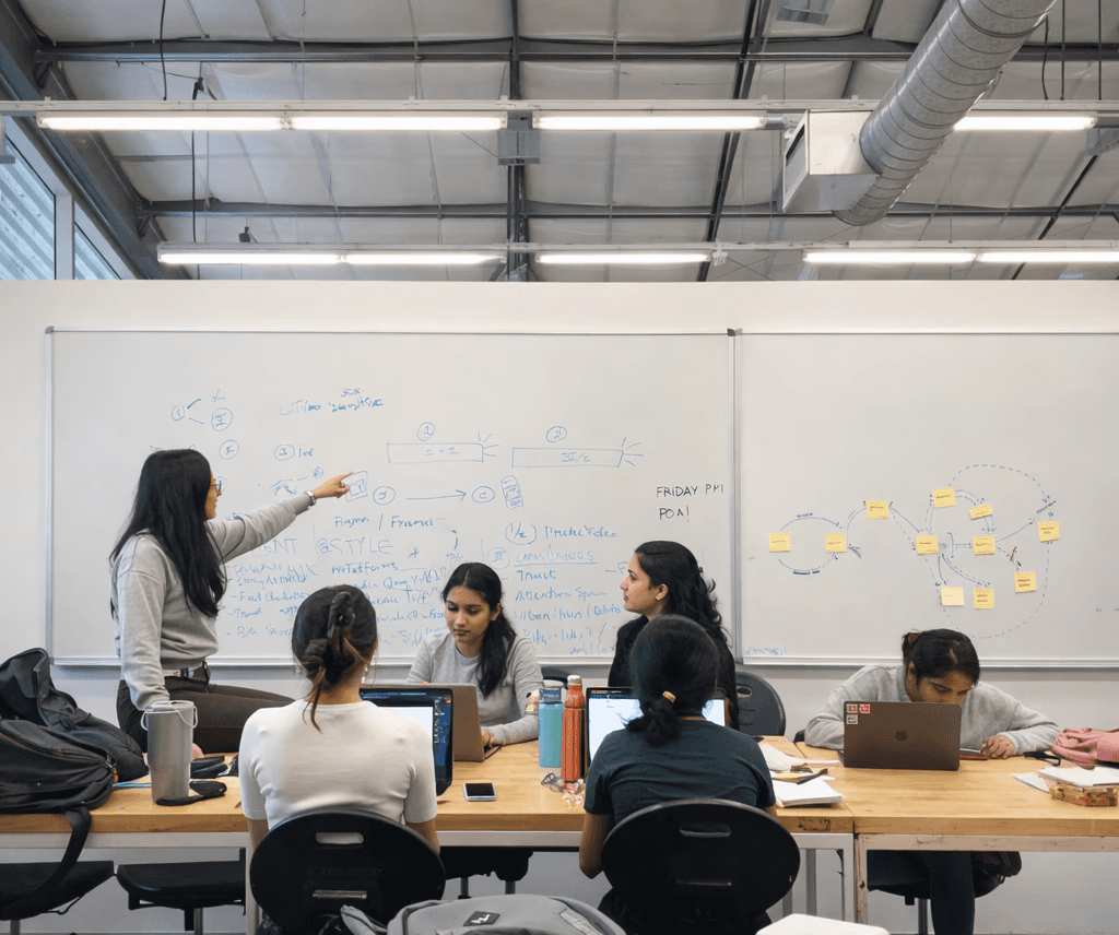 Empty historic lecture hall with curved wooden seating and a classical painting on the wall