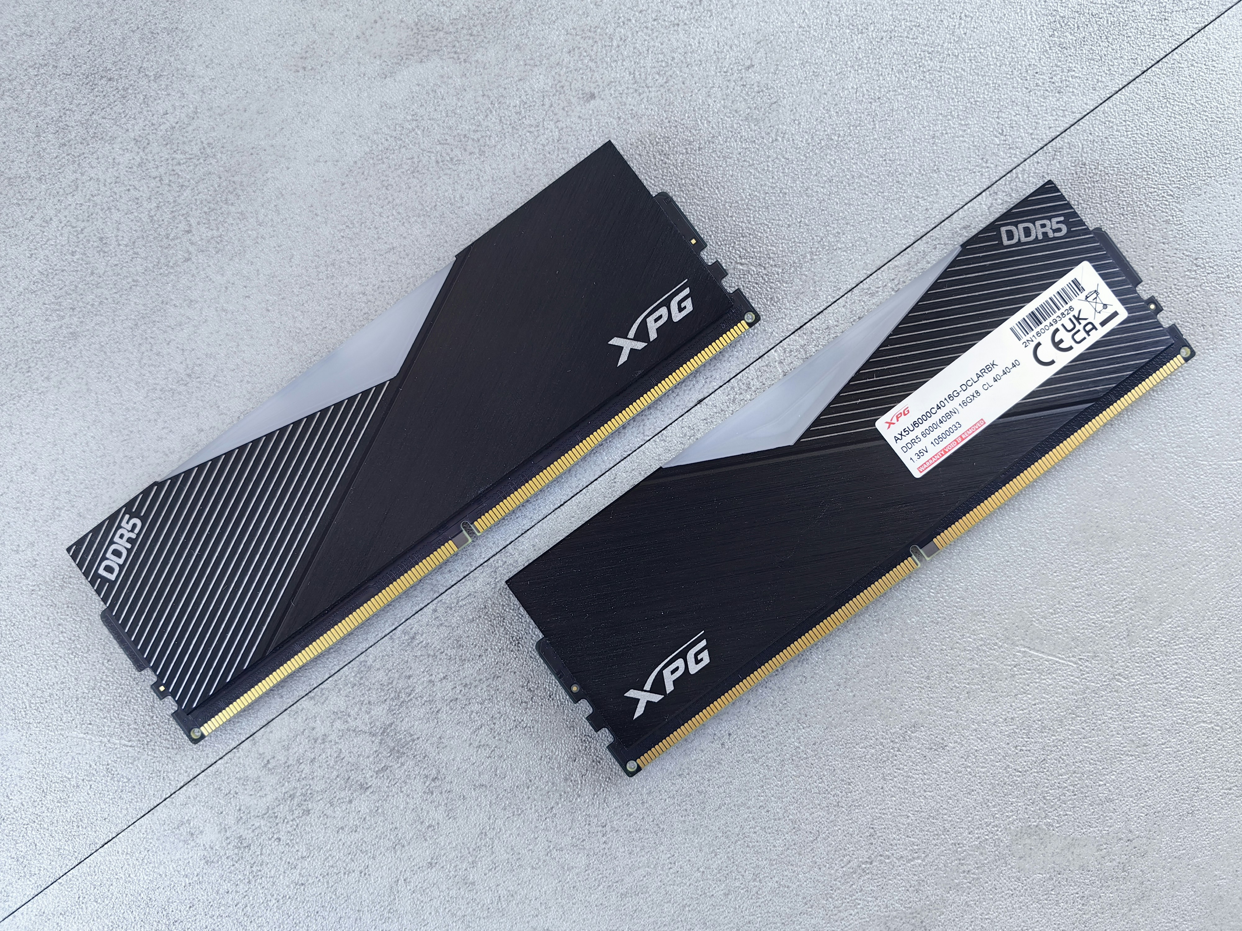 Photo of two DDR5 RAM sticks placed on a light surface, representing computer memory hardware.