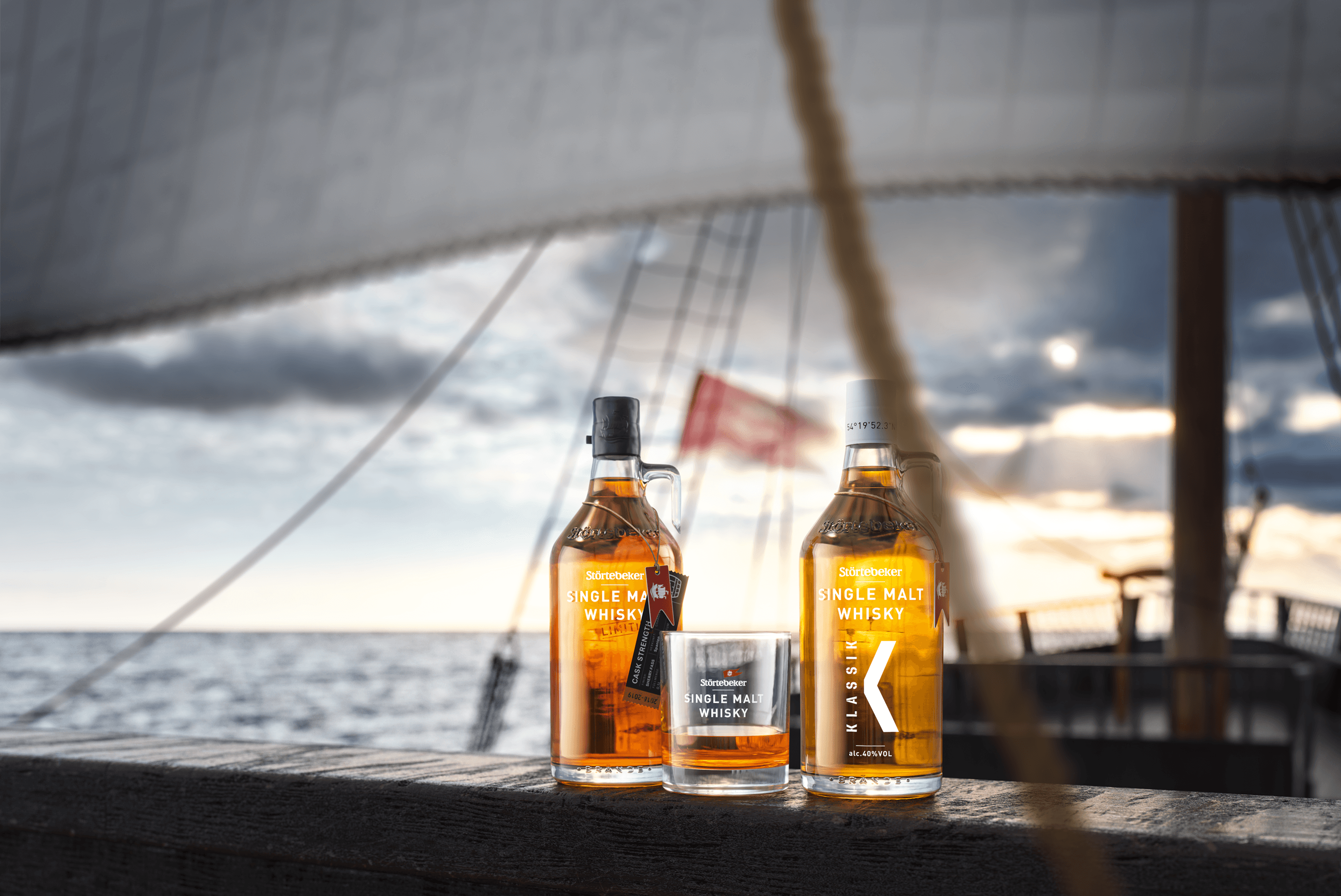 Störtebeker whisky bottles and glass on deck