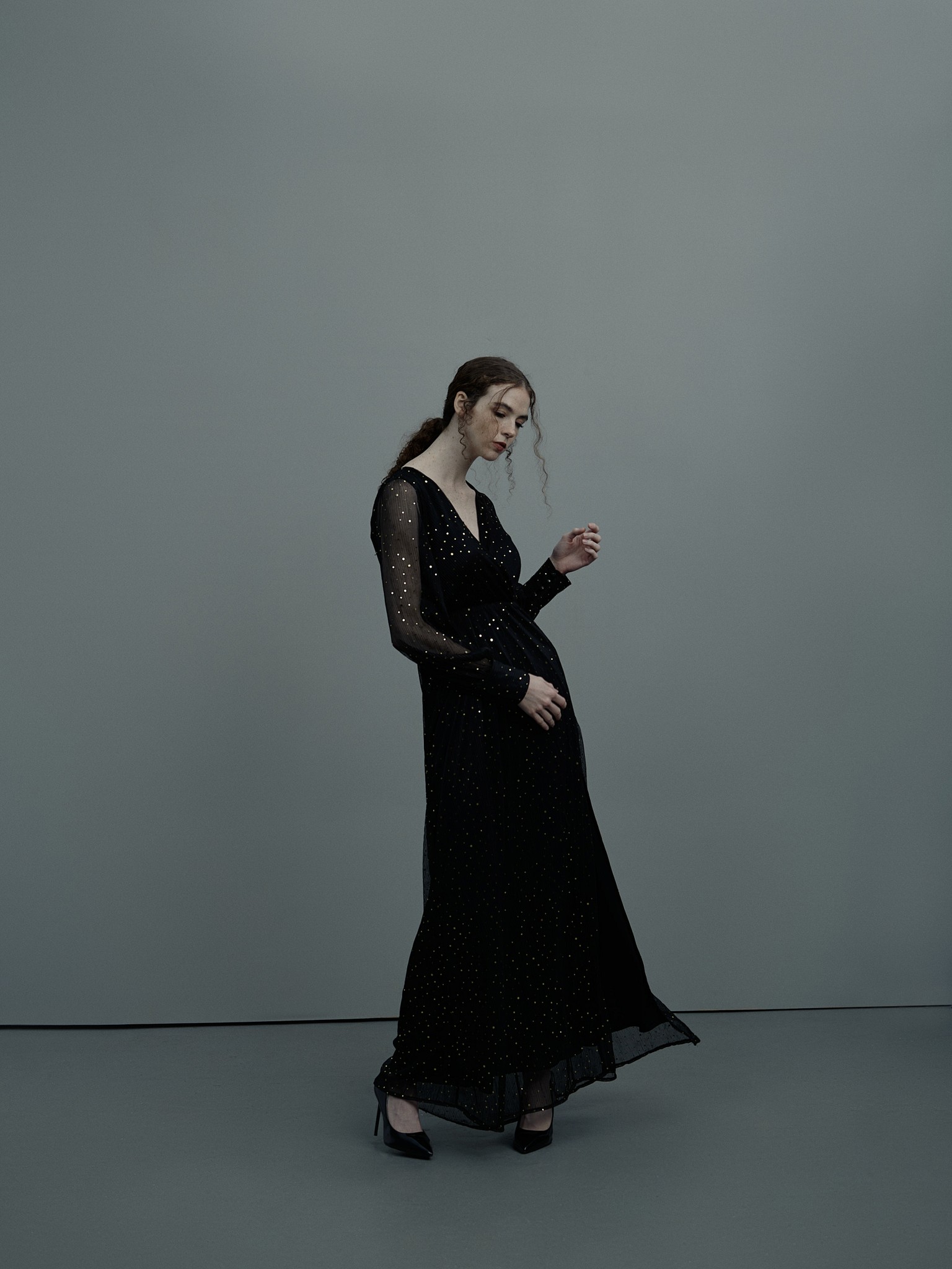 Fashion portrait of a young woman moving in a poetic and expressive way. Shot in the photo studio in New Orleans, by photographer Craig Mulcahy. 