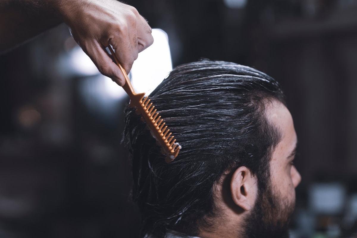 Man getting hair styled at a barbershop