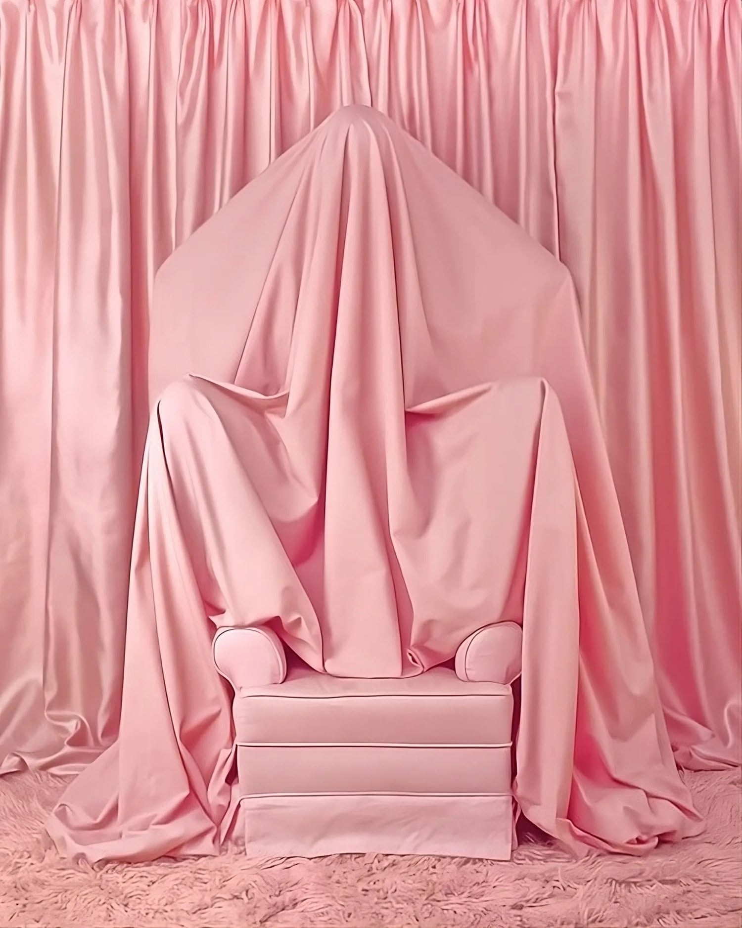 A pink room with a pink chair draped in pink fabric, surrounded by pink curtains and a pink fluffy rug.