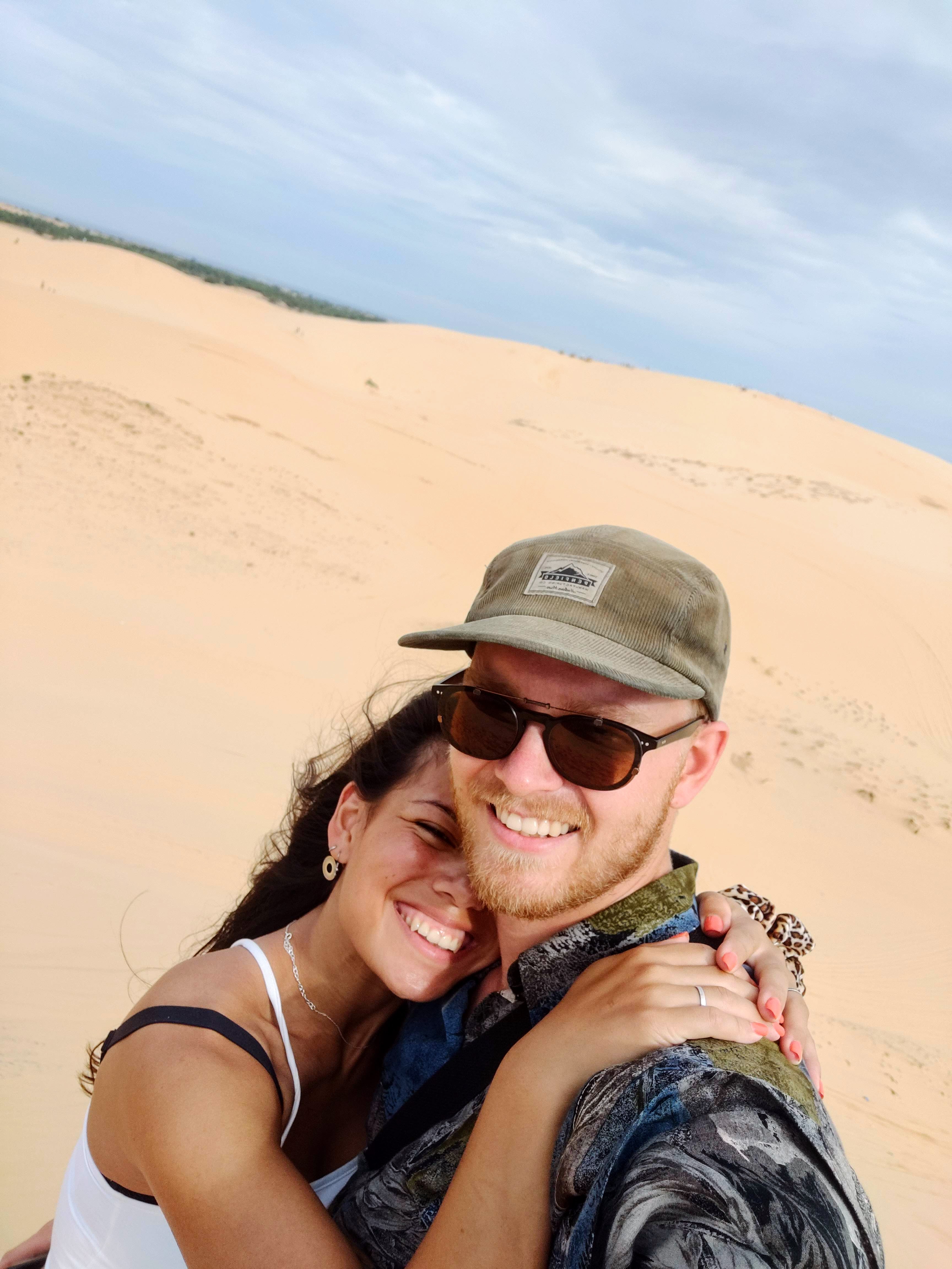 Couple portrait with dog on field