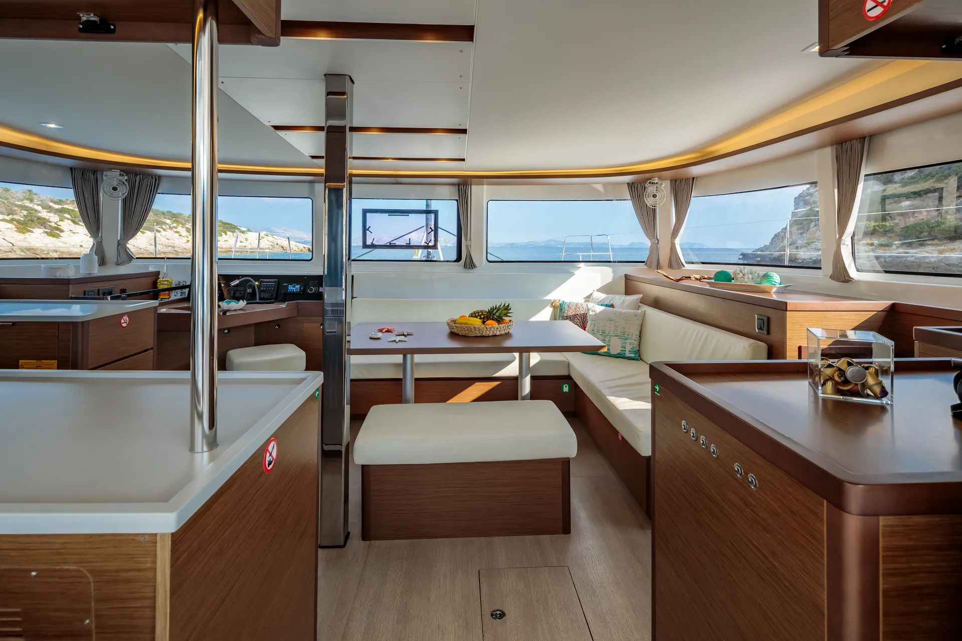 White Rock 36 speedboat with captain at helm cruising calm blue waters near Paros coastline with hills in background.