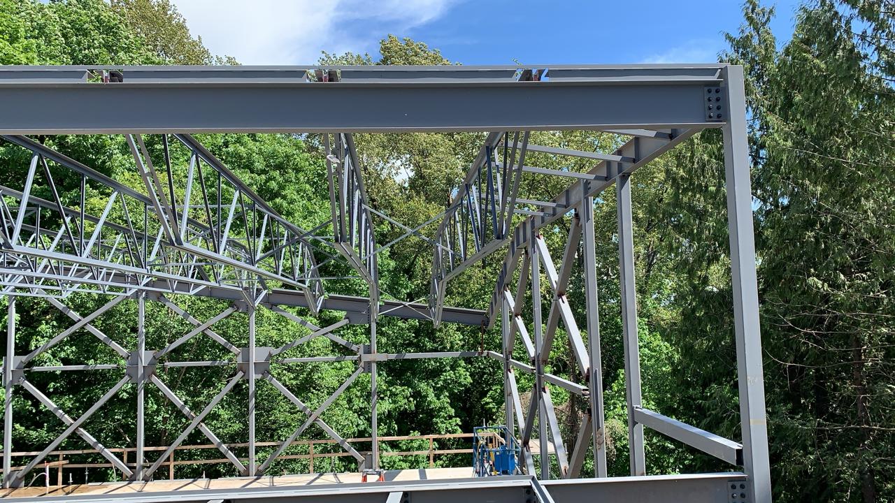 Structural steel roof members, beams and bracing at a wooded site