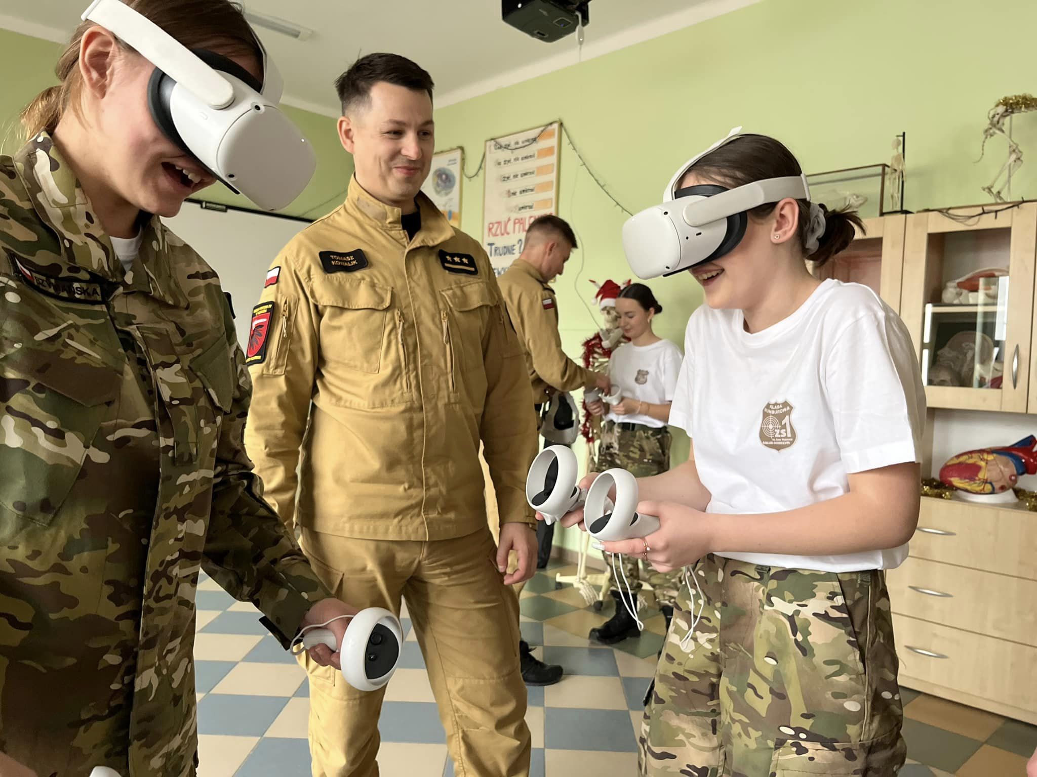 Children participating in fire safety training with the help of a firefighter, wearing VR headsets.