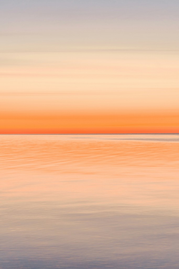 a large body of water with a boat in the distance