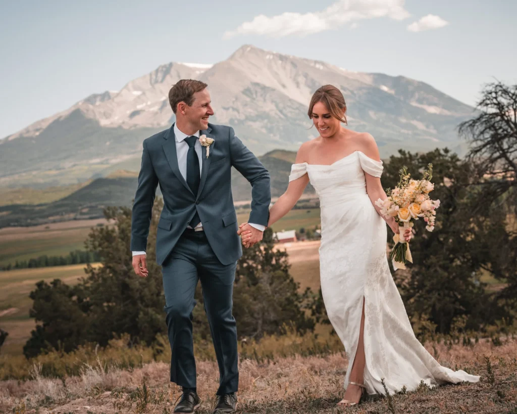 Elegant bride and groom portrait with mountain scenery at Carbondale Private Ranch Wedding
