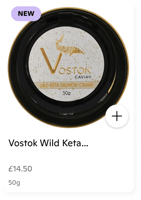 A single product listing card on a white background:  Product Name: Vostok Wild Keta Salmon Caviar, 50g.  Price: £14.50.  Visuals: The card features a top-down view of a circular caviar tin with a white label, gold lettering, and a gold sturgeon illustration.  Indicators: A light purple "NEW" badge is in the top-left corner, and a circular "+" button is on the right side for adding to a basket.