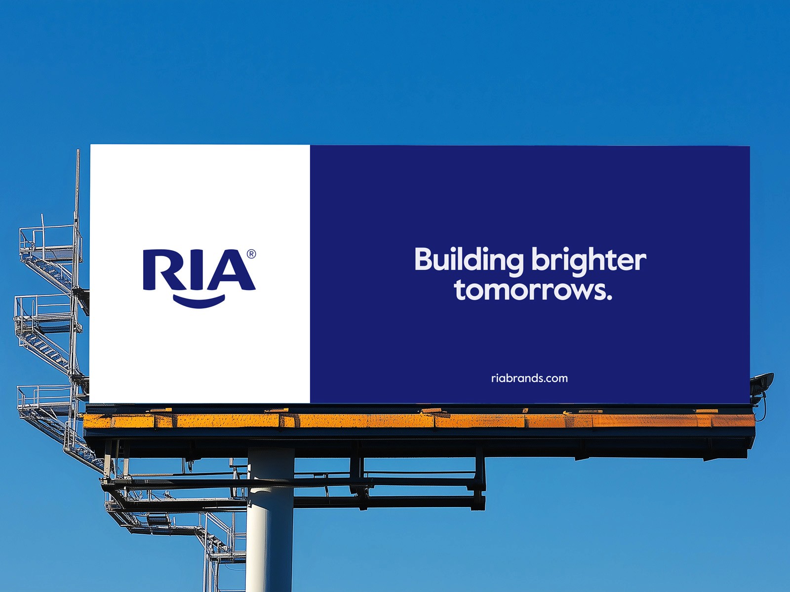 RIA logo beside the line “Building brighter tomorrows.” on a blue and white billboard.
