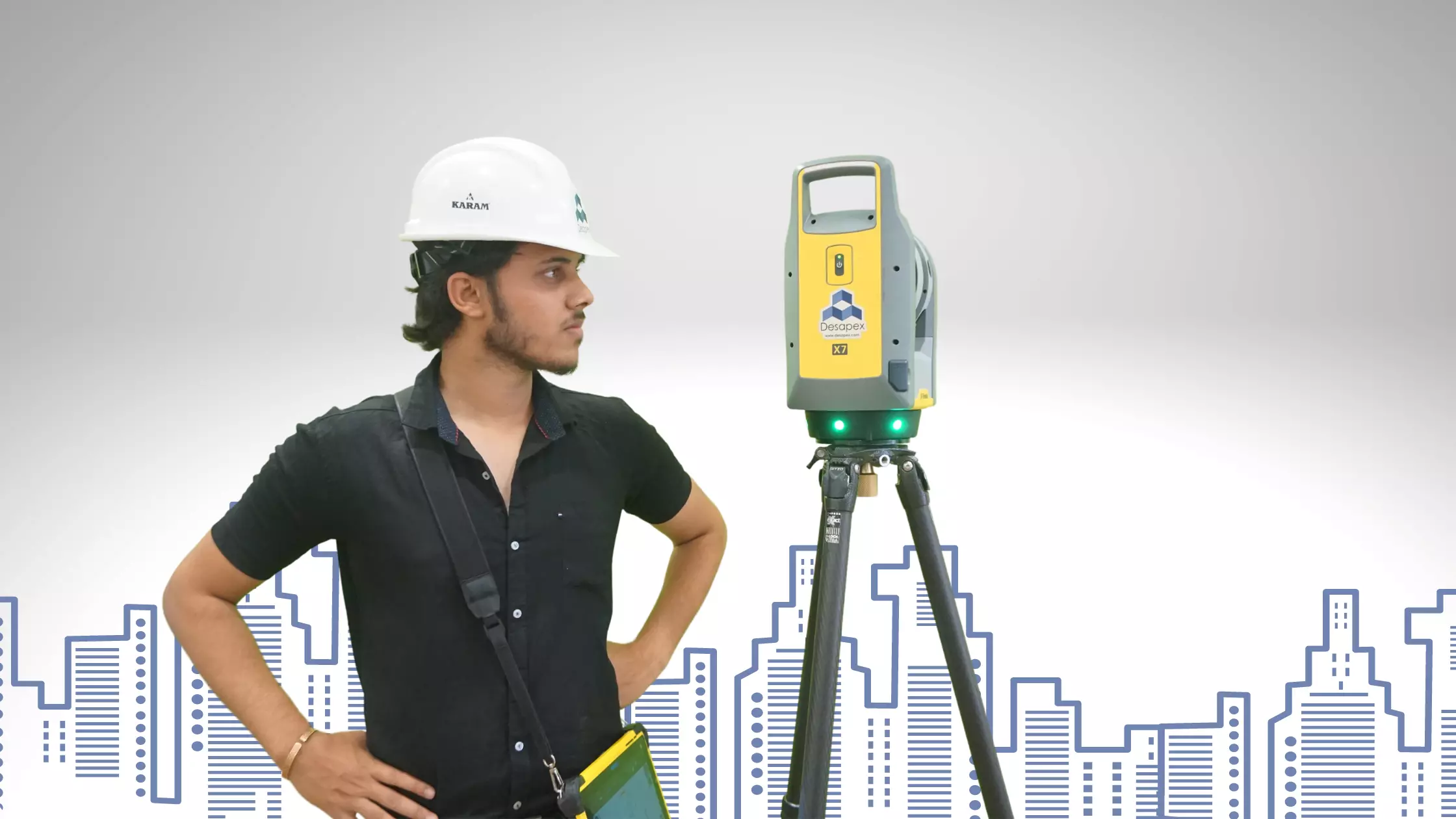 A man stands while two people sit at a table in an office setting, smiling and engaged in conversation. The mood is friendly and collaborative.