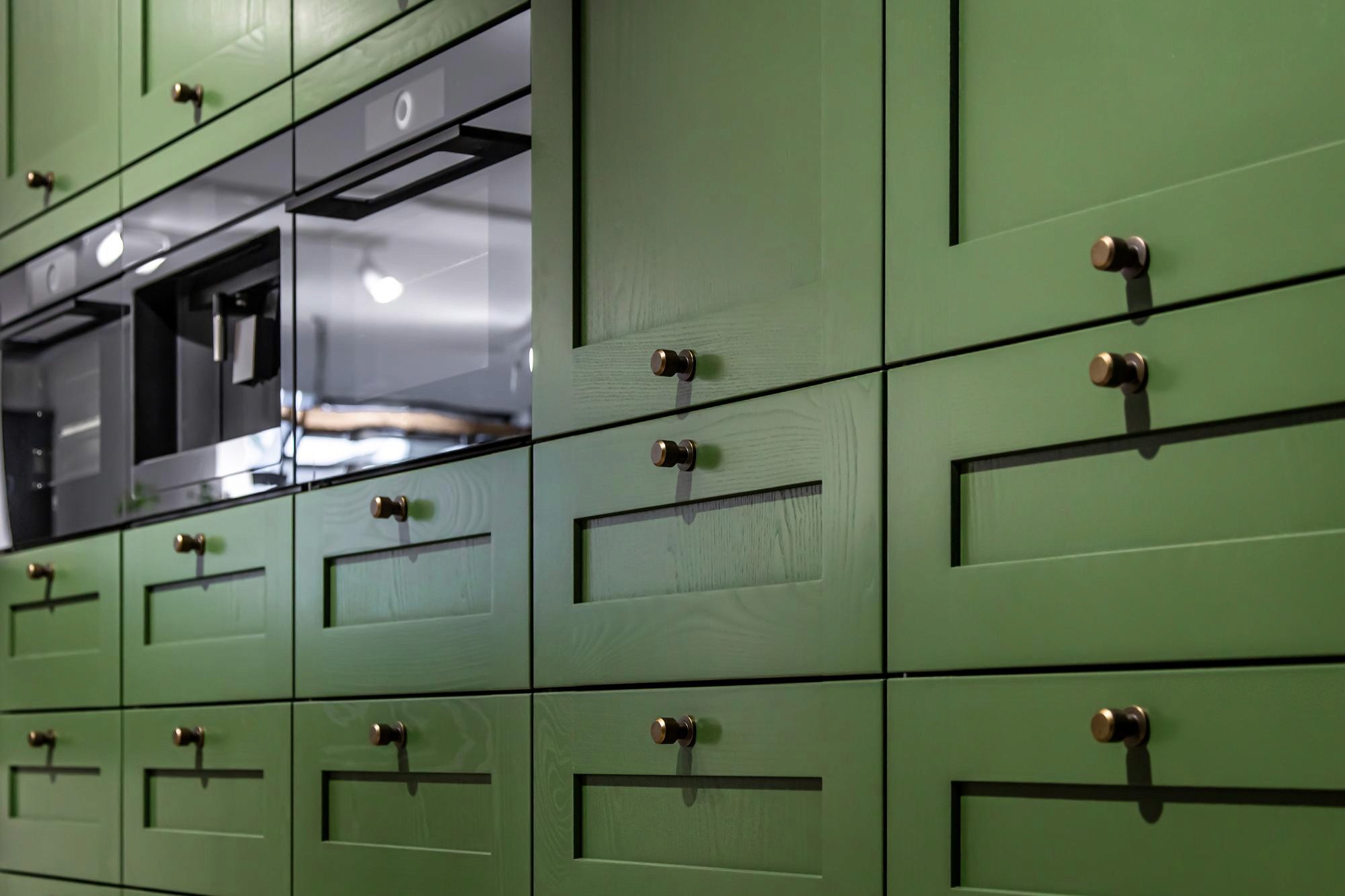 A close-up of high-quality natural wood cabinetry with luxurious hardware