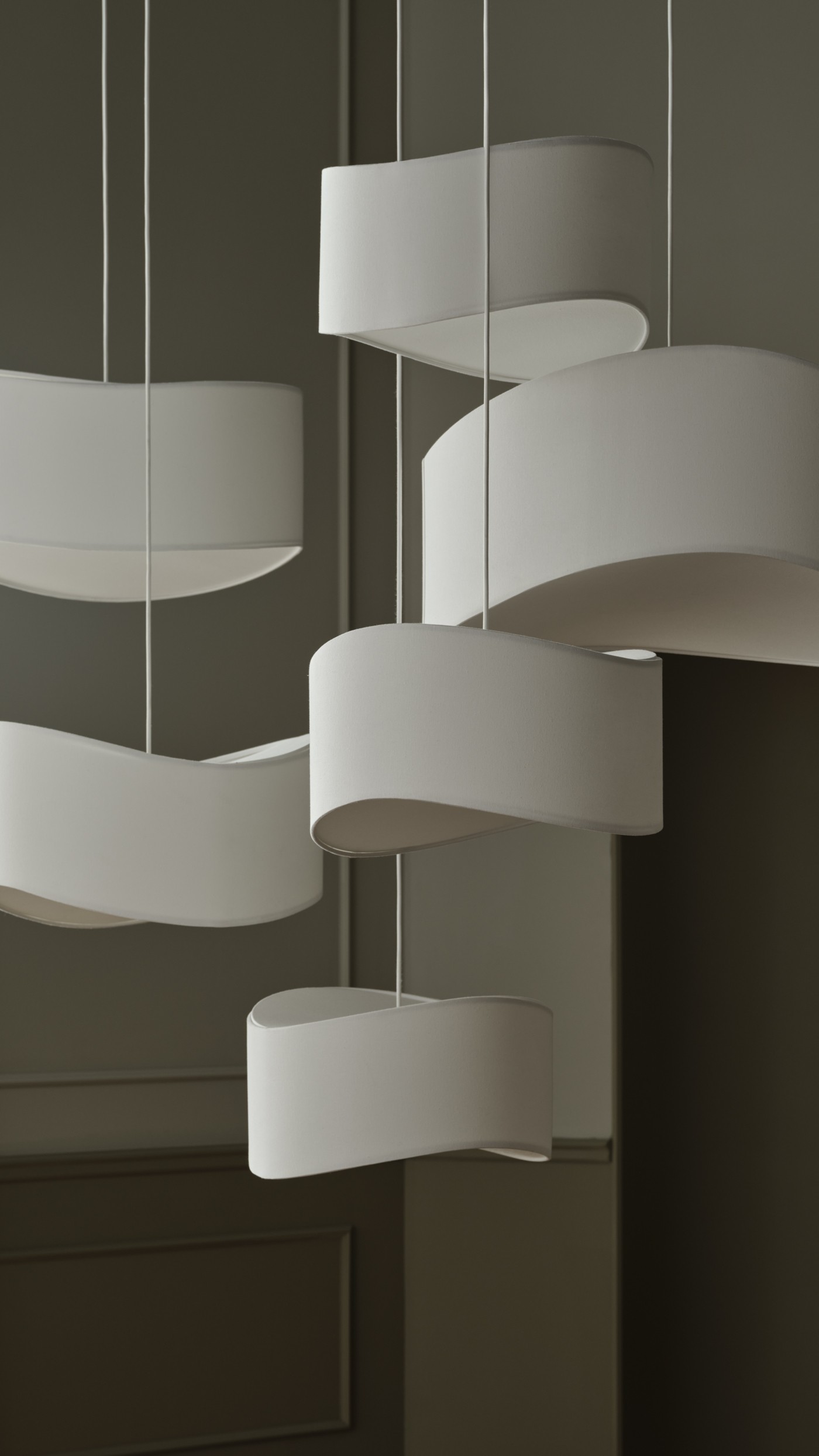 Tajo lighting series with sculptural white pendants and table lamp in airy interior designed by Asger Risborg Jakobsen