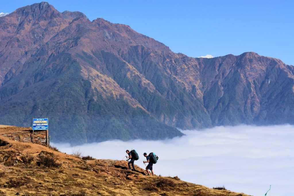 Hikers above the clouds - beginner mountain climbers