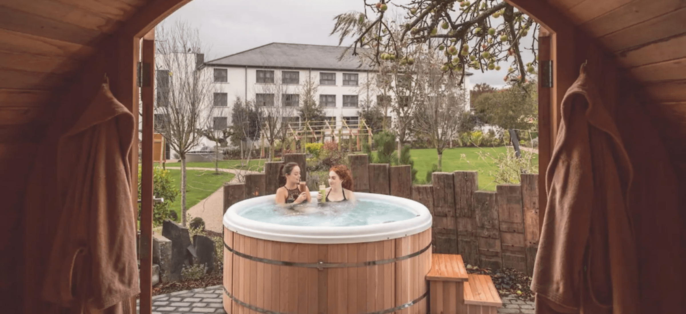 Two females in wooden hottub spa