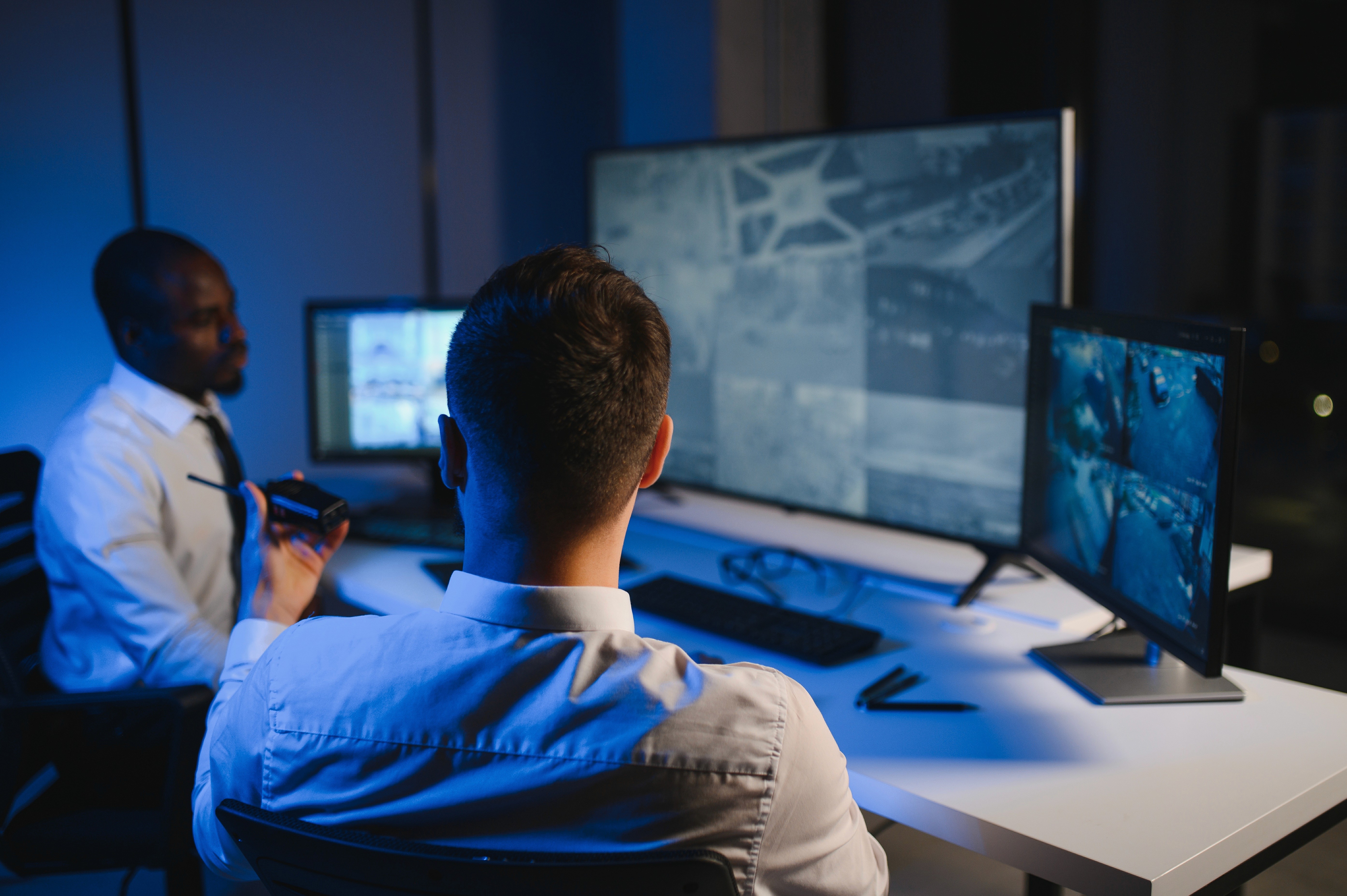 Blurred portrait of a person in an orange patterned shirt with glowing glasses, creating a futuristic and artistic vibe.