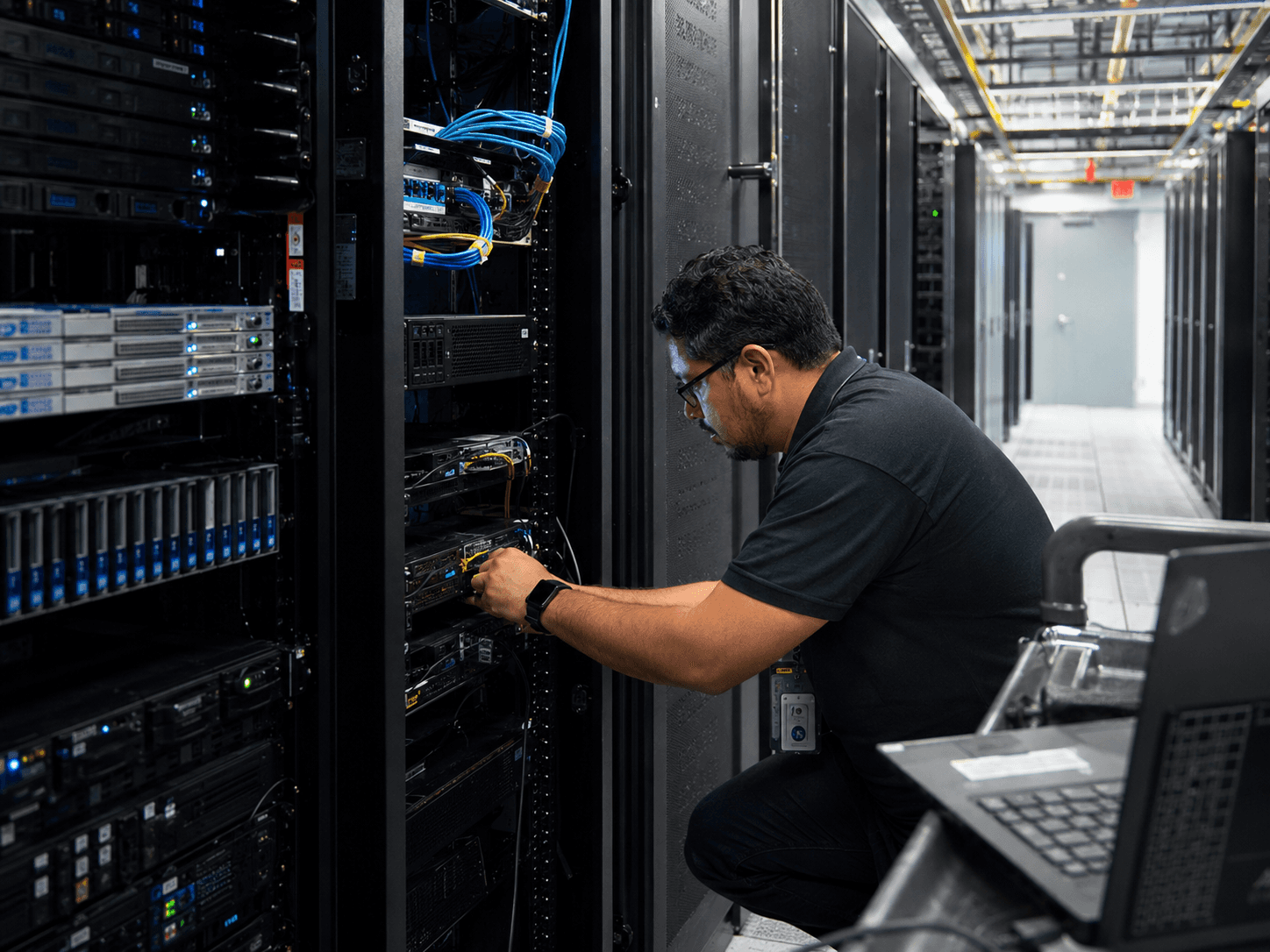Data center engineer working on server