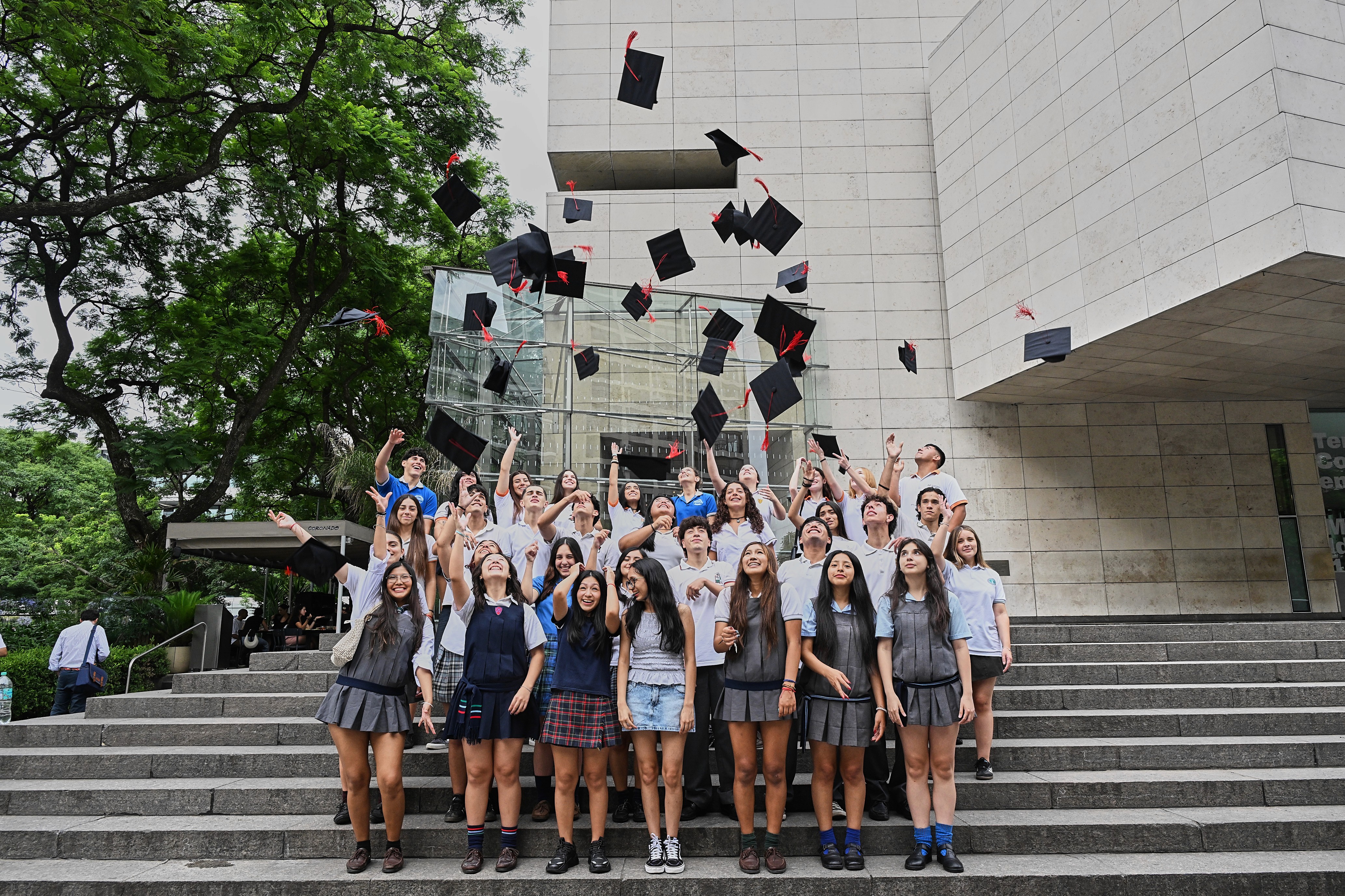 five children smiling while doing peace hand sign