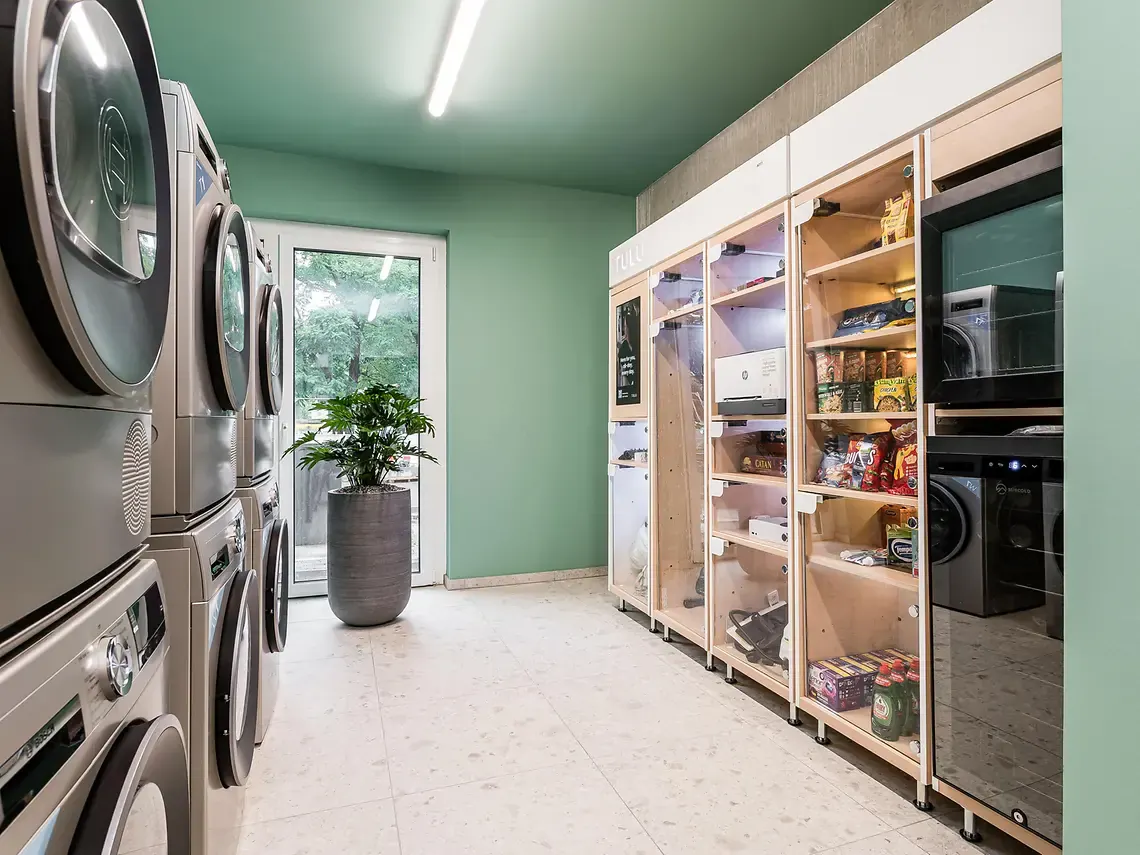 Laundry facilities at student accommodation in Berlin with modern washing machines and dryers